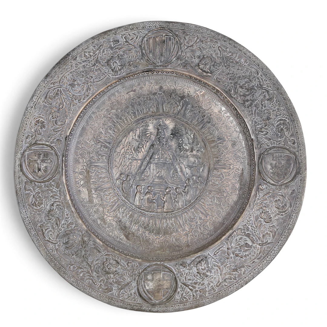 Ornamental silvery copper platter depicting Our Lady of Montserrat