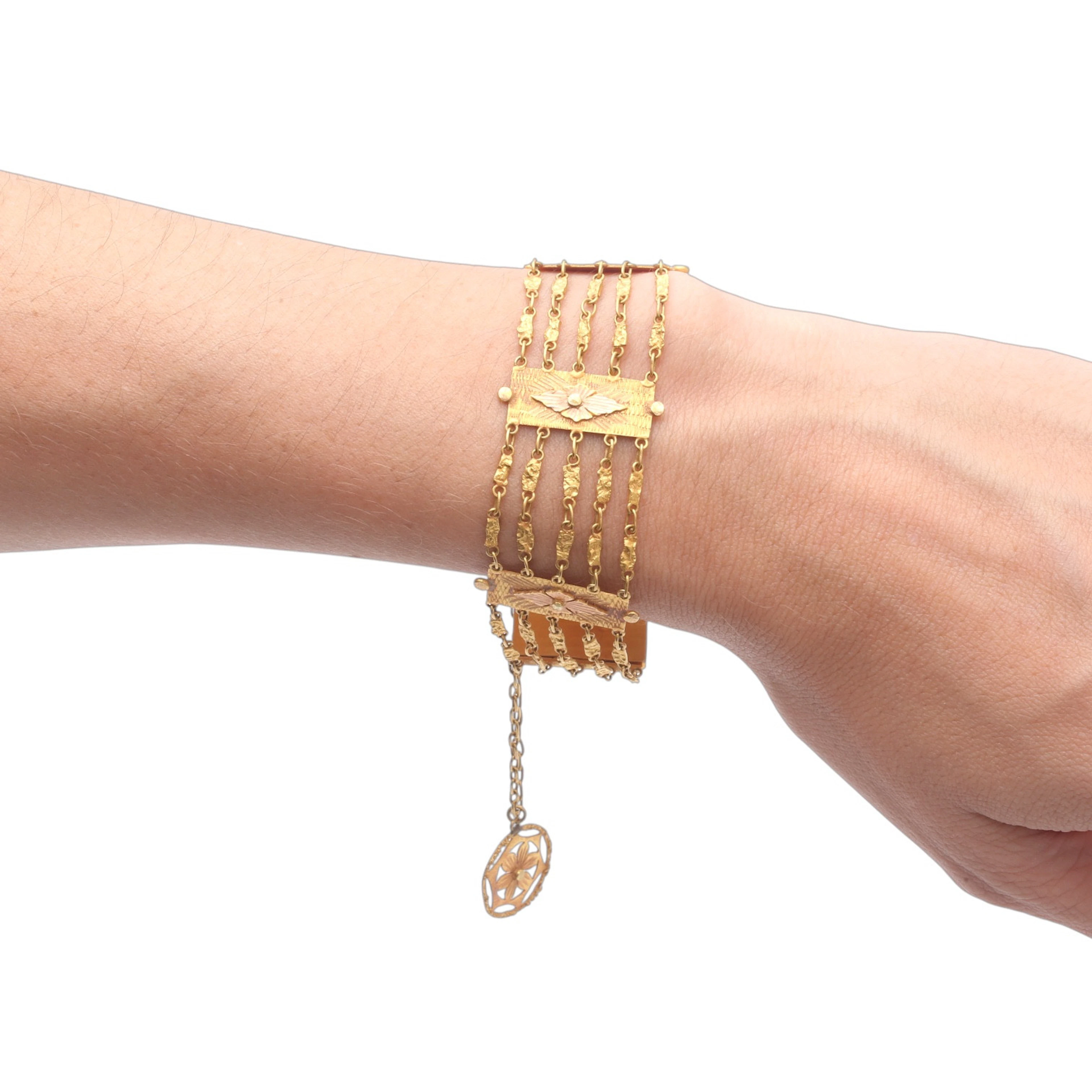 Wide floral bracelet with gold chains, circa 1960.