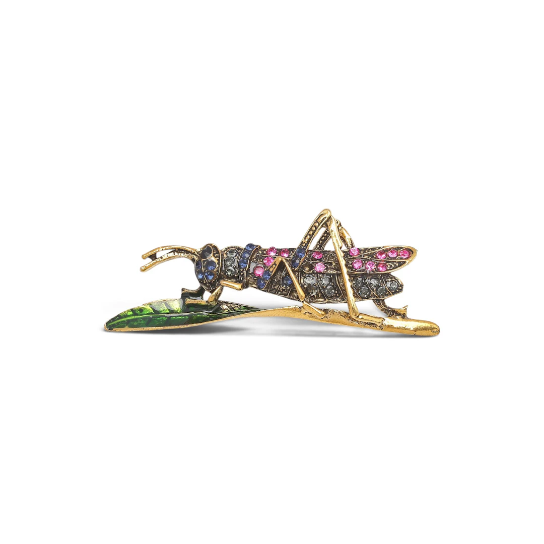 Grasshopper-shaped brooch.