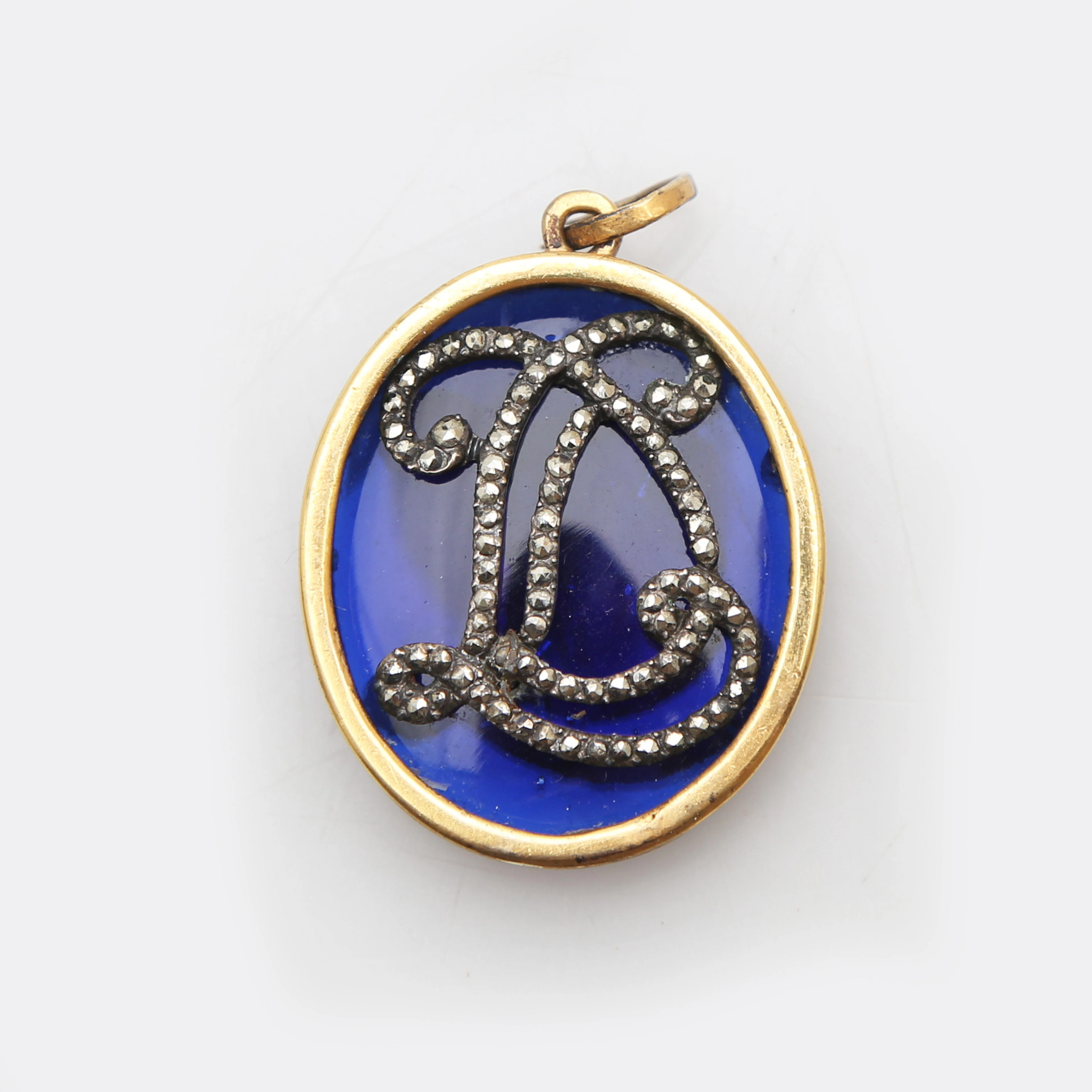Brass locket with blue glass plaques and marcasites inlay, 19th Century.