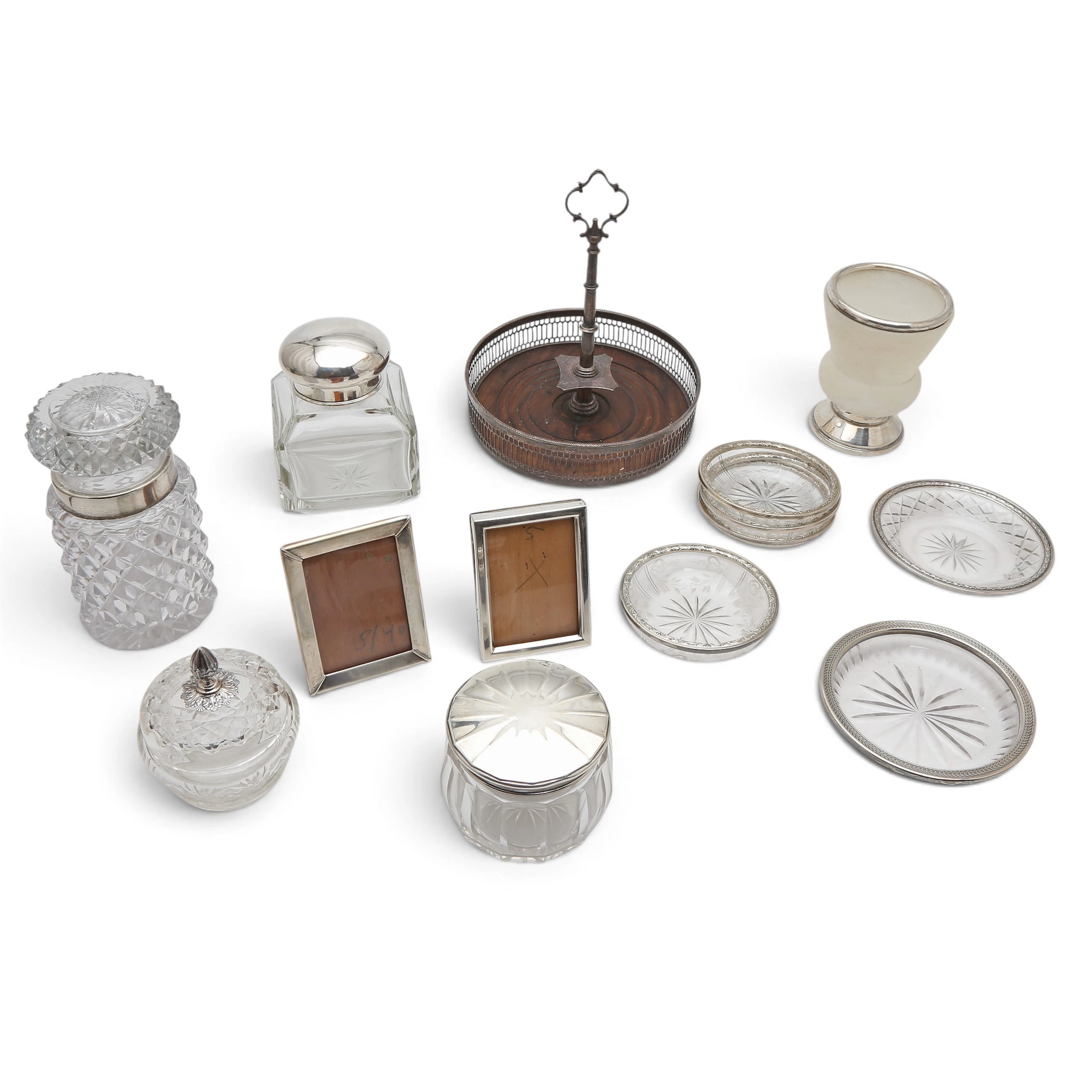 Various serving objects and small frames in silver, glass, alabaster and wood.