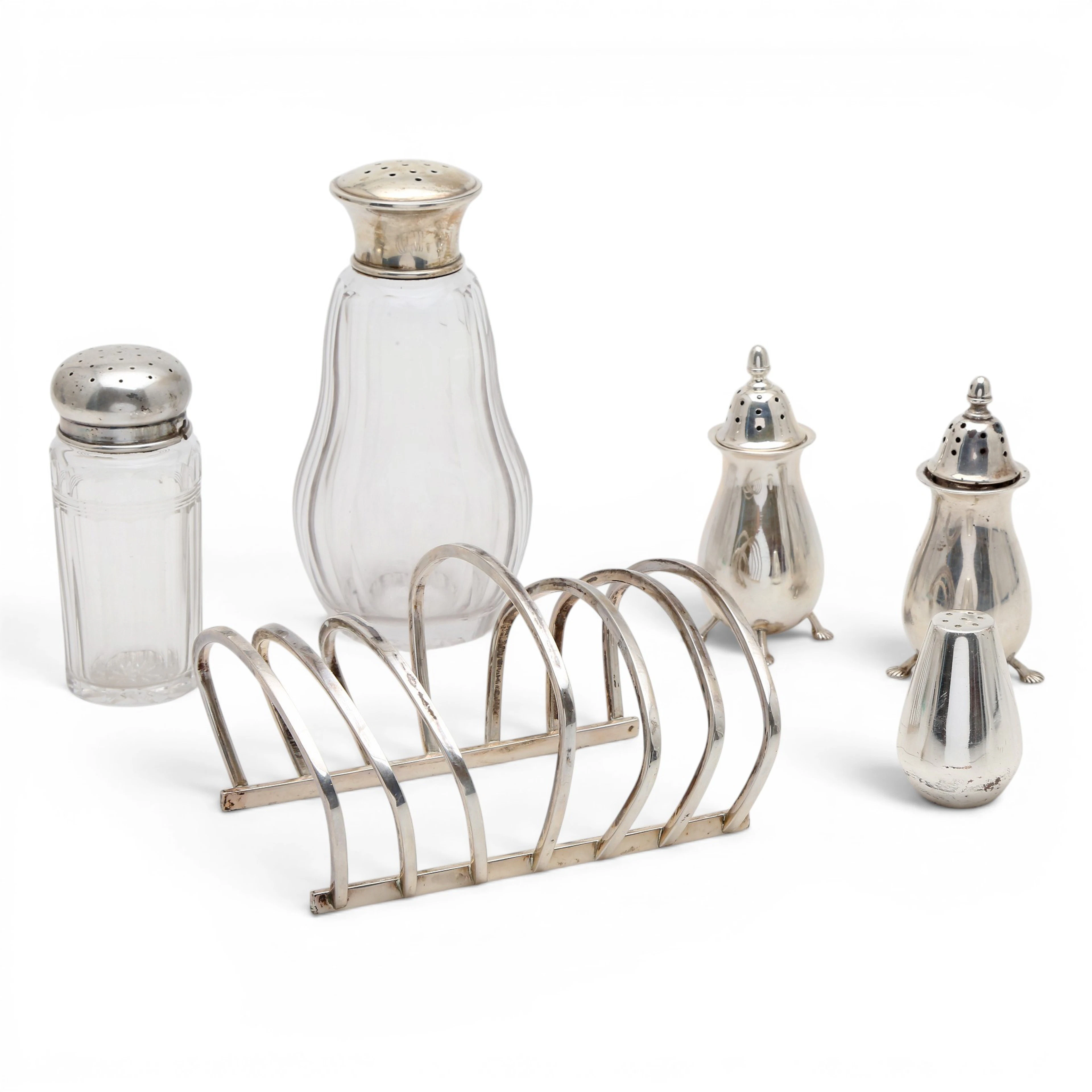 Four silver and glass salt cellars and toast rack, mid-20th century.