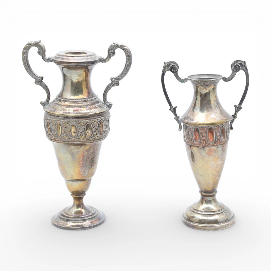 Two silvery metal amphorae.