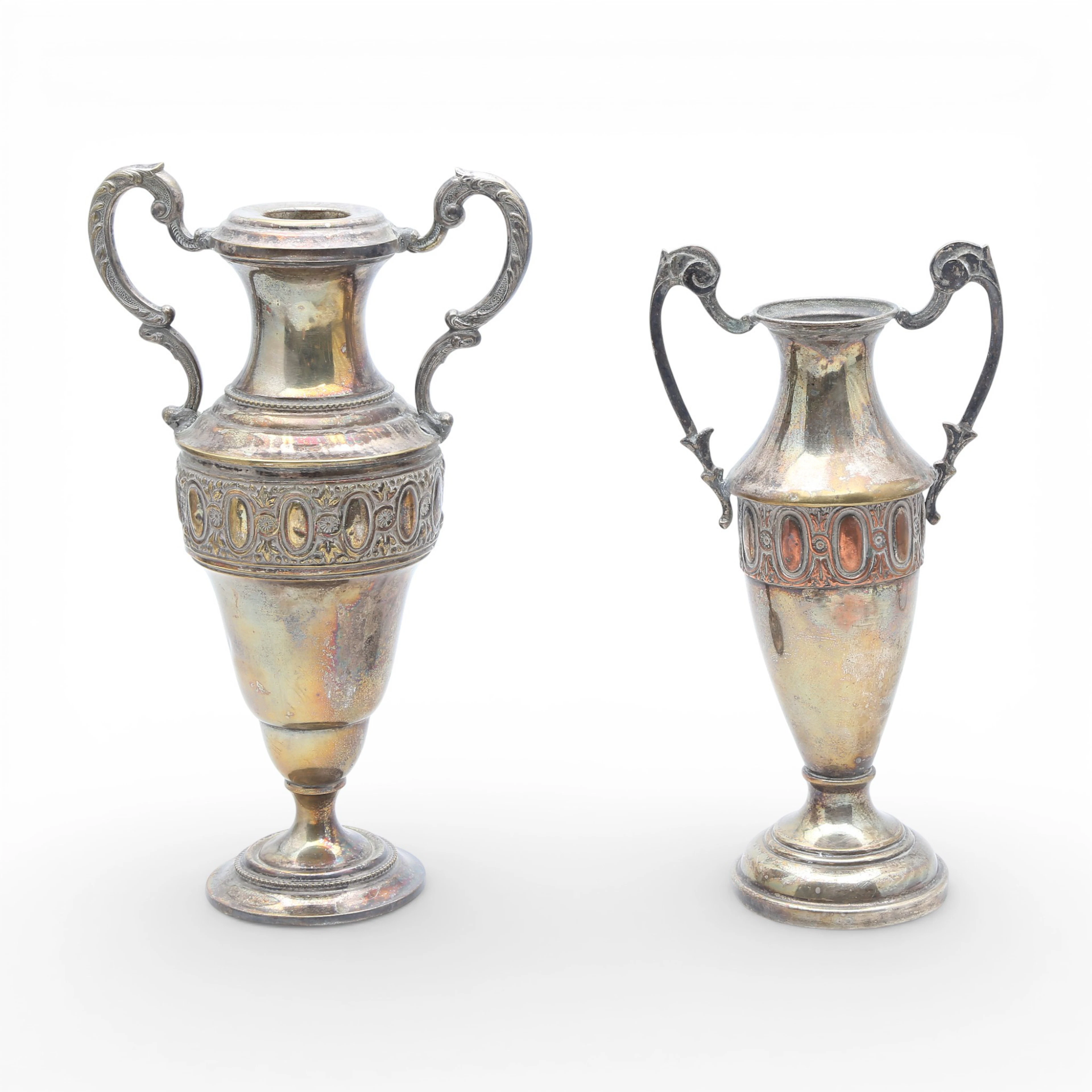 Two silvery metal amphorae.