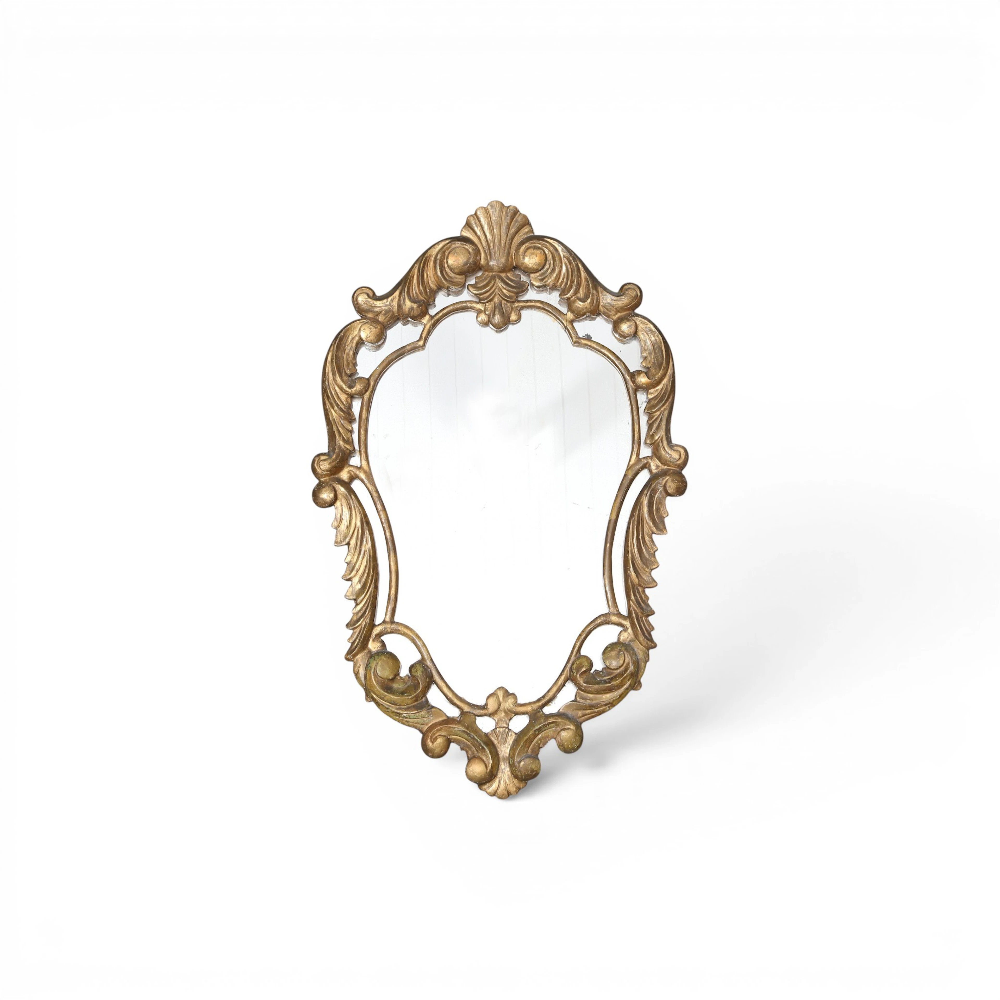 Ornamental mirror in carved and gilt wood, circa 1930.