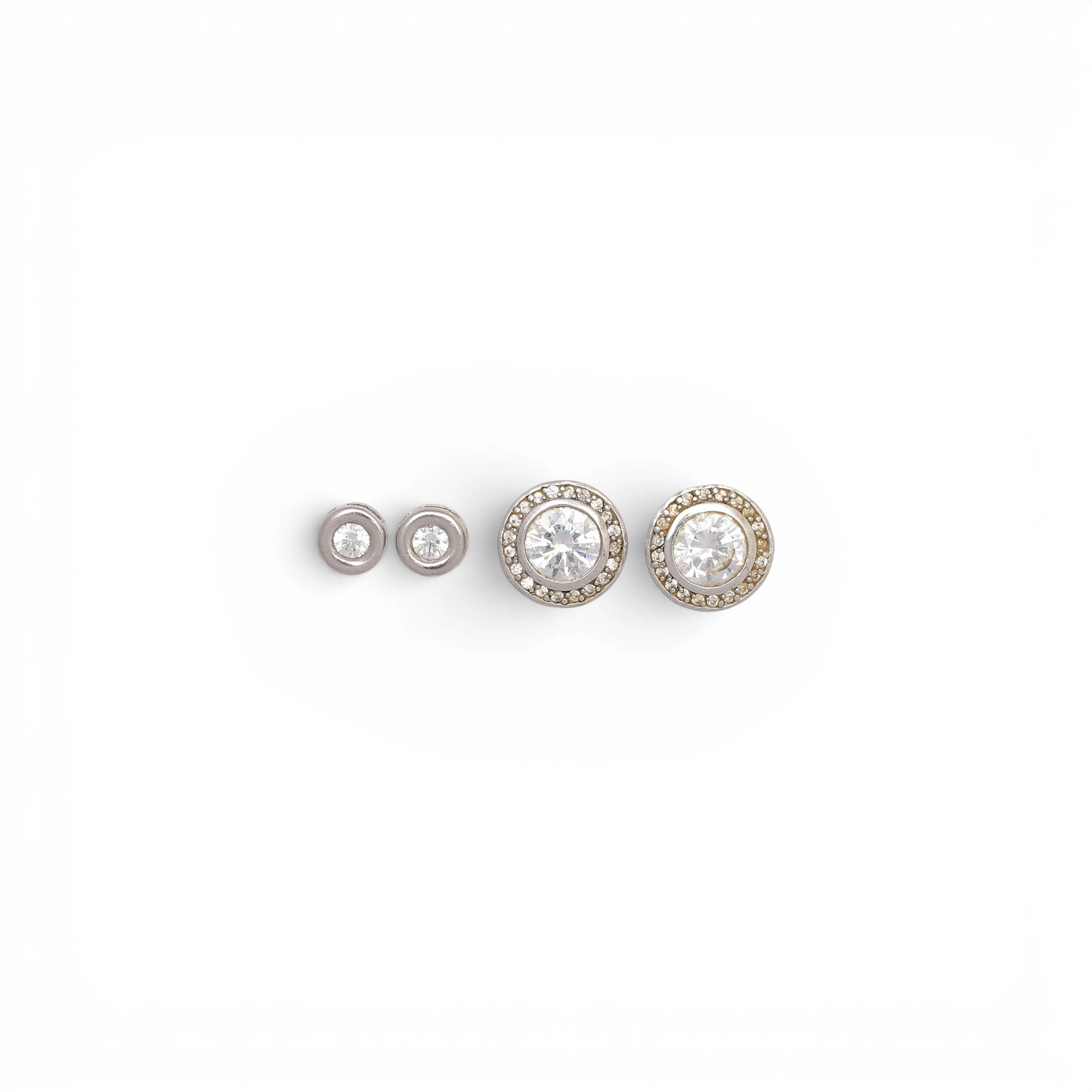 Two pairs of stud earrings.