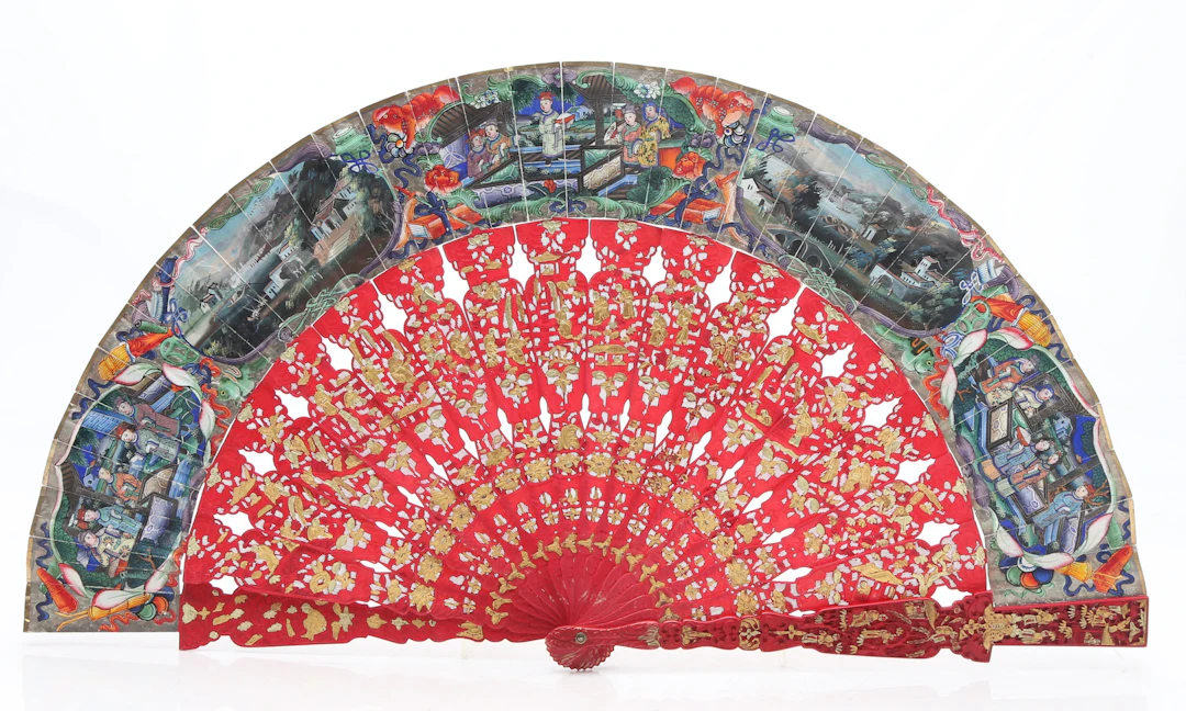Chinese "thousand faces" fan with faux cinnabar lacquer sticks and