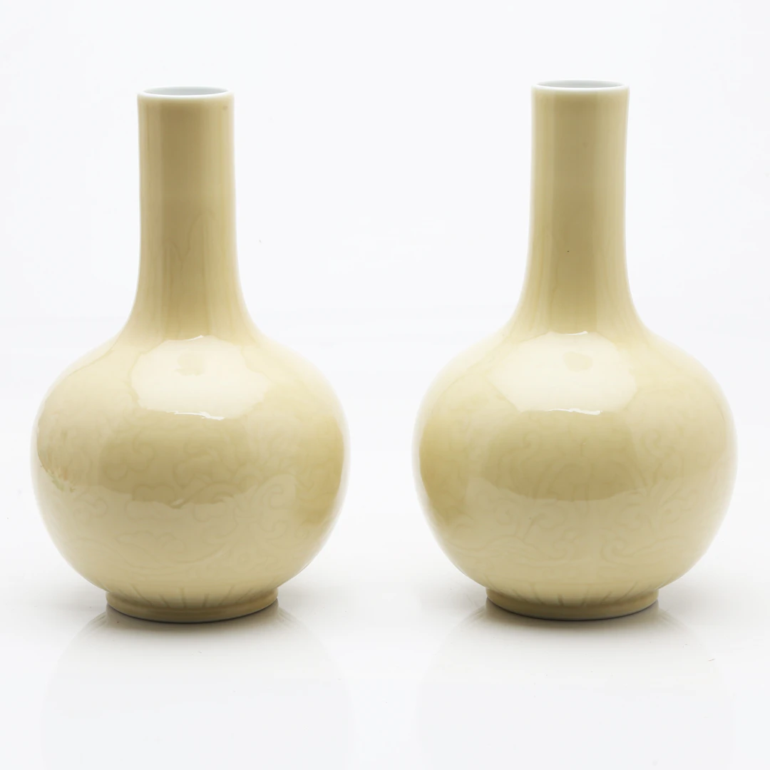 Pair of Chinese Qianlong-style pale yellow porcelain vases, 20th Century.