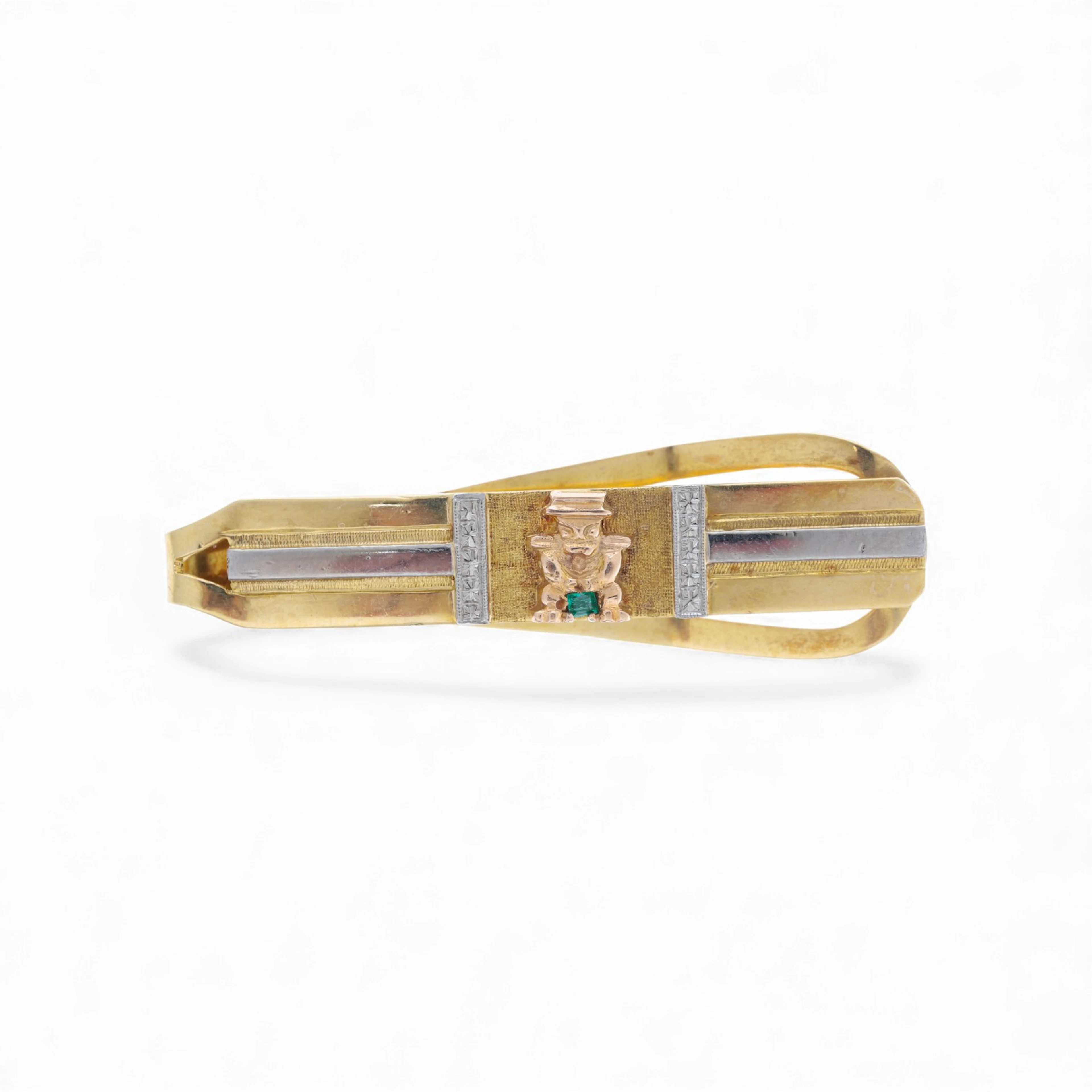 Gold and emerald tie pin.