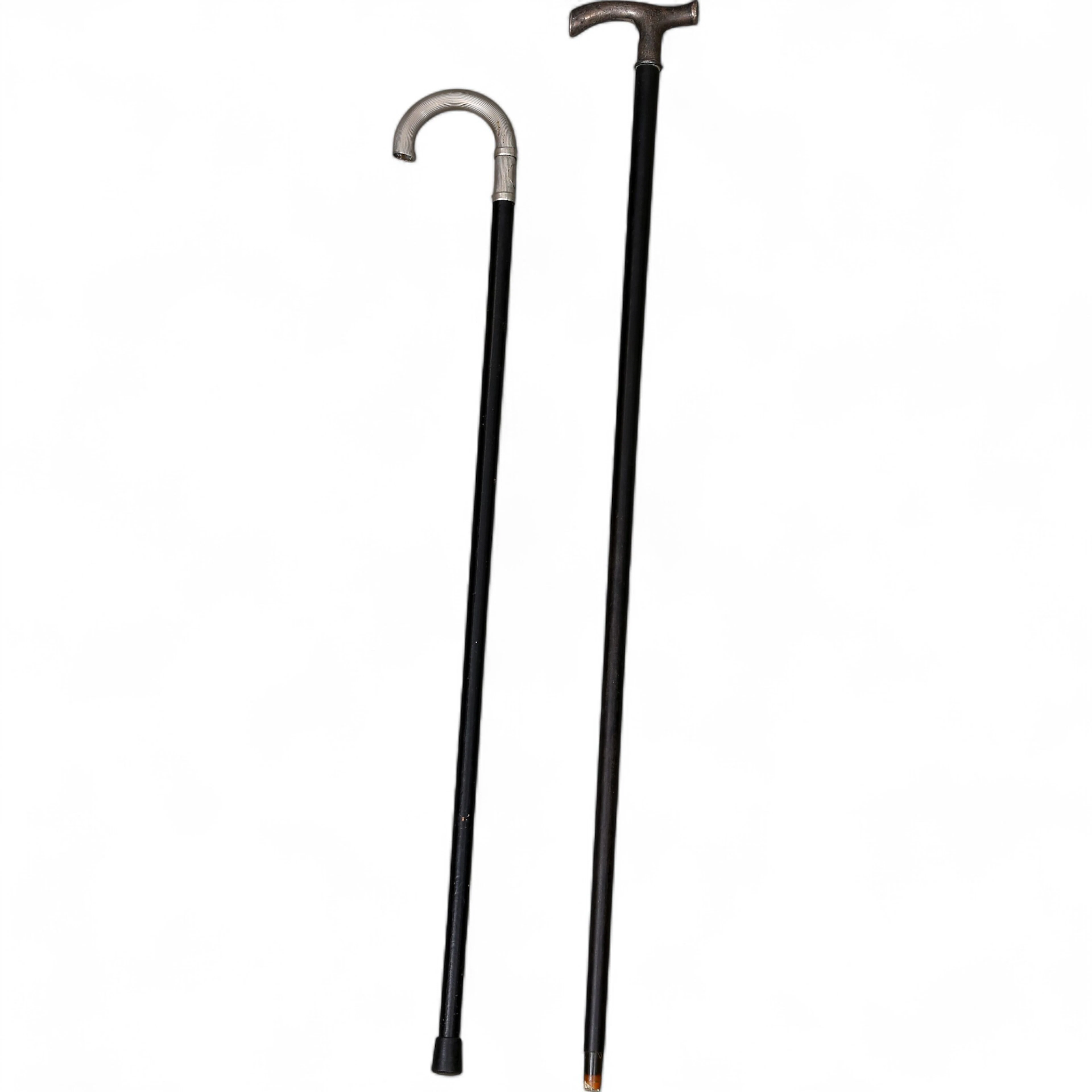 Two canes with silver and silvery metal grips, first half of the 20th Century.