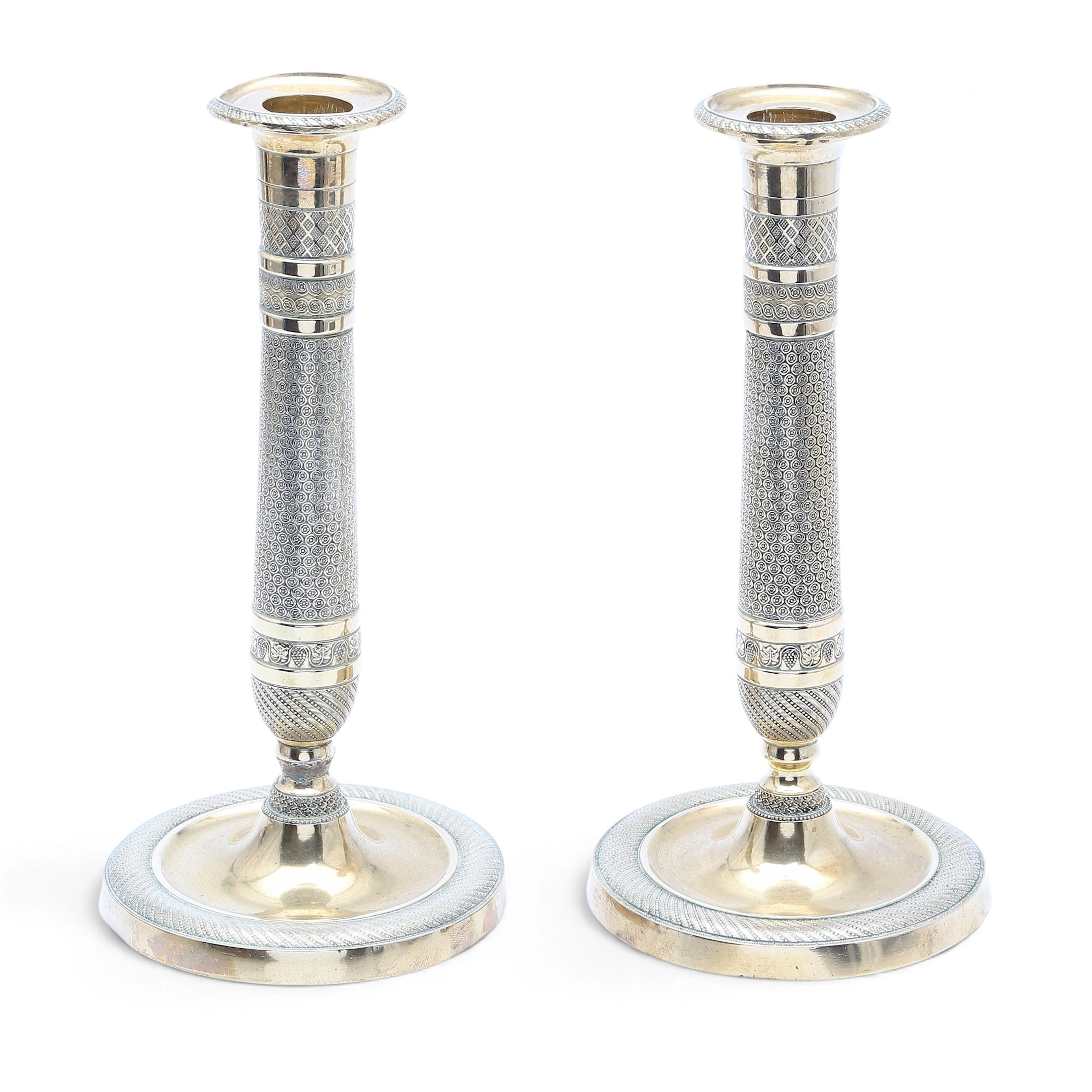 Pair of French Charles X gilt bronze candlesticks, 19th Century.