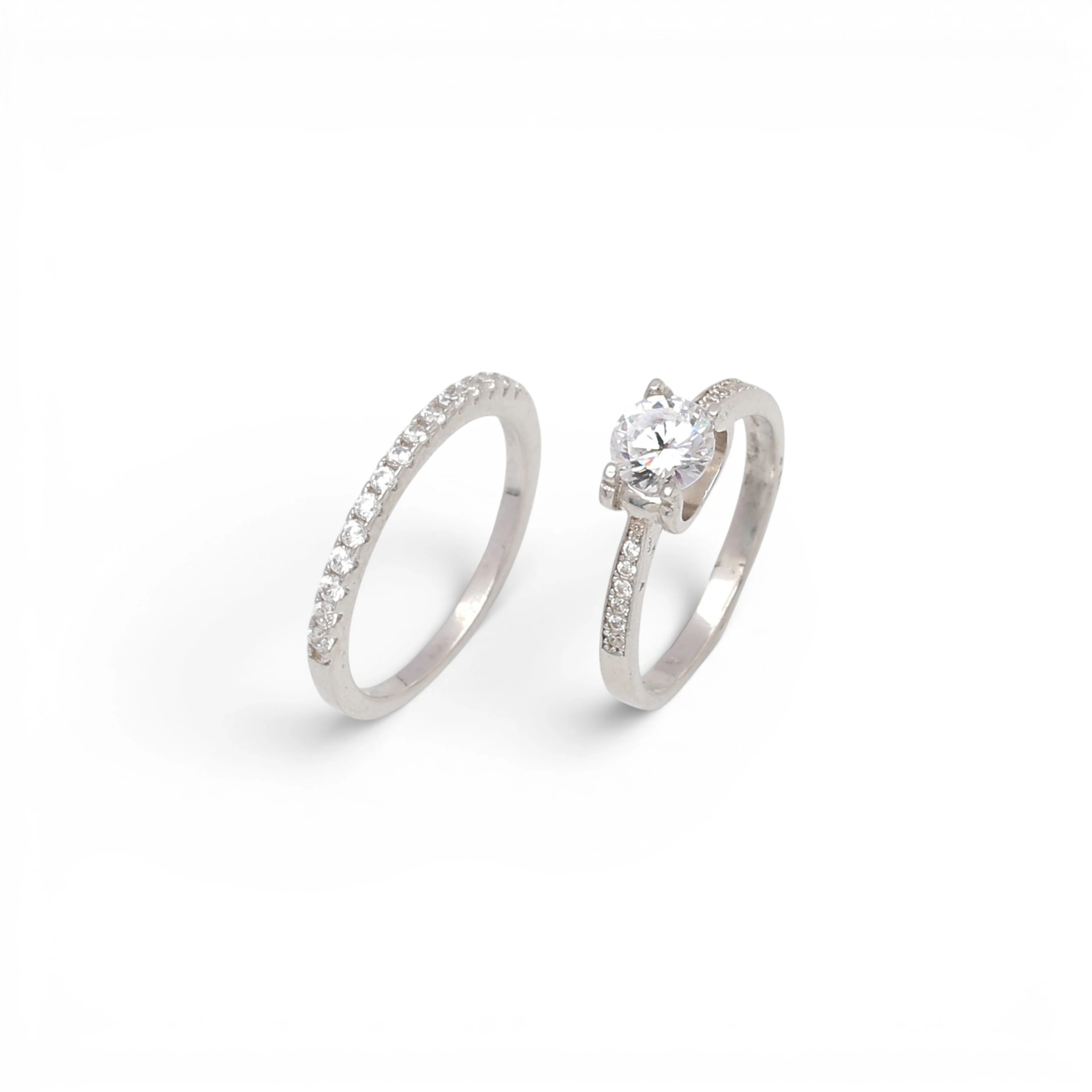 Solitaire ring and half-band ring with zircons.