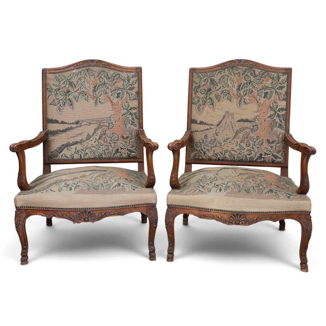 Pair of Regency-style armchairs in carved walnut, 20th Century.