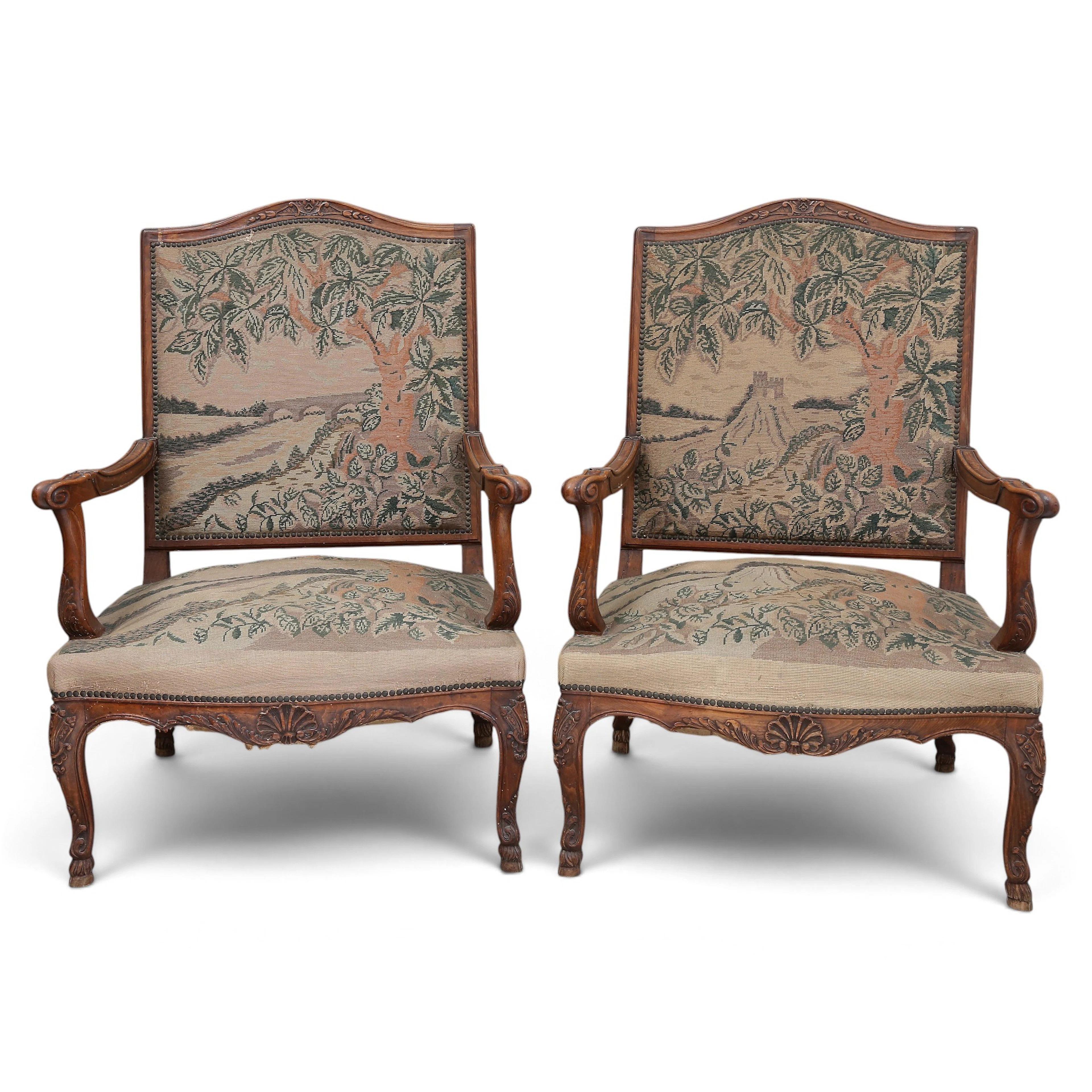 Pair of Regency-style armchairs in carved walnut, 20th Century.