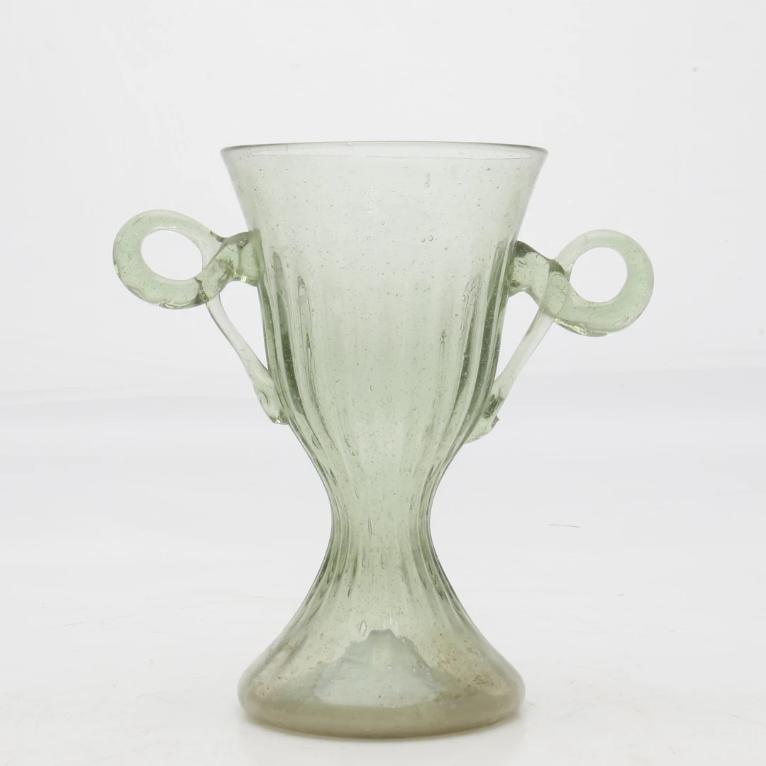 GOBLET with handles in blown and partially moulded green glass, El