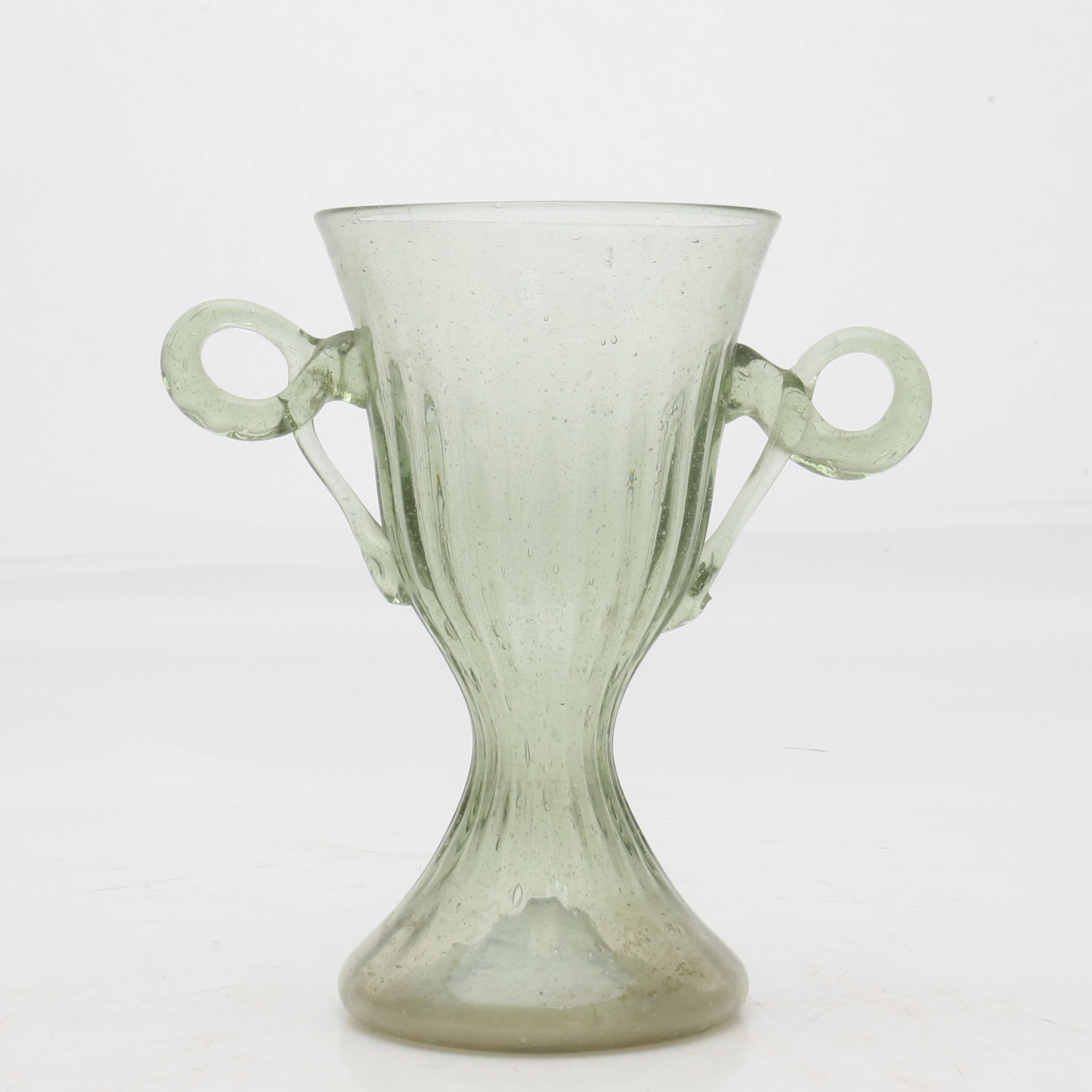 GOBLET with handles in blown and partially moulded green glass, El
