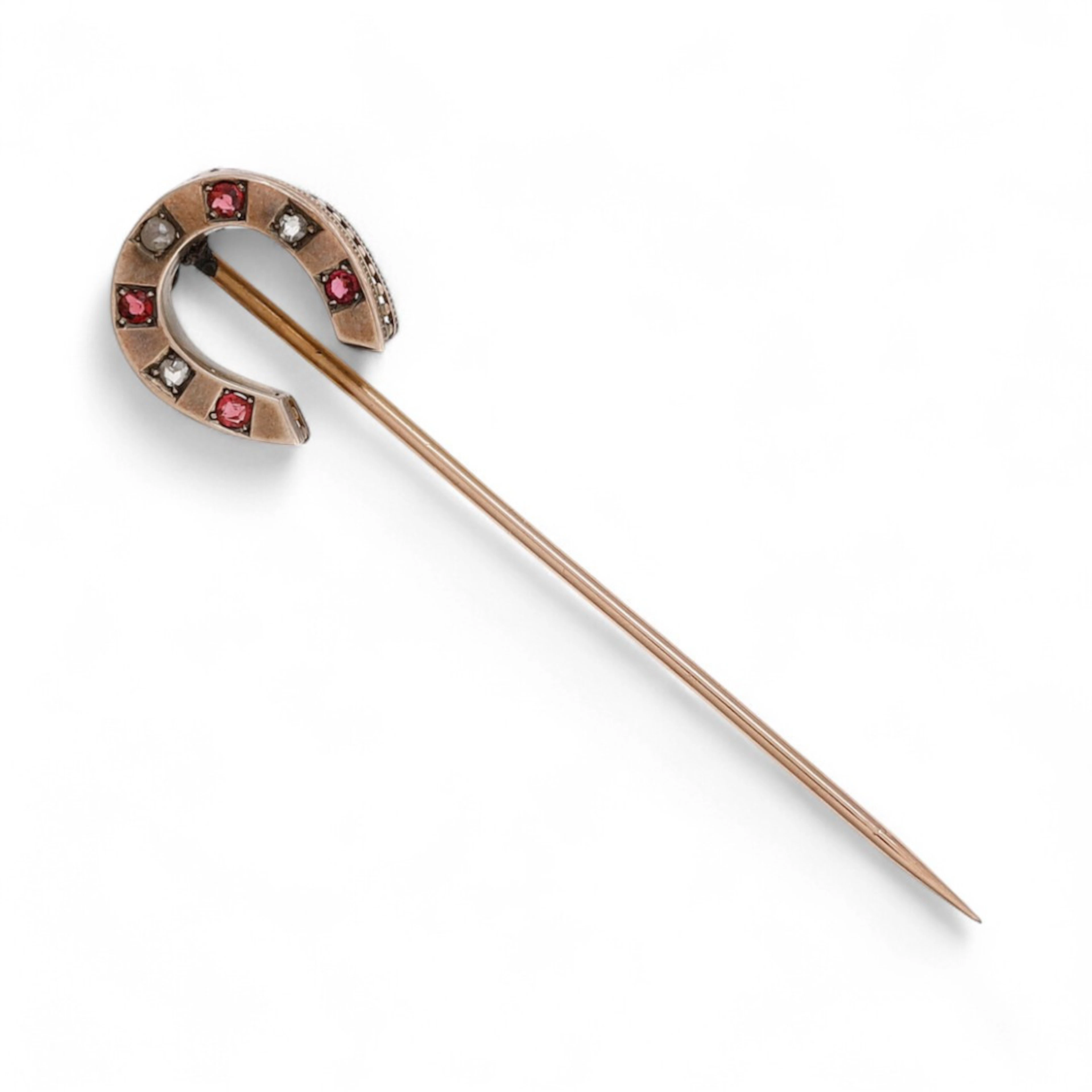 Horseshoe-shaped diamonds tie pin, circa 1940.