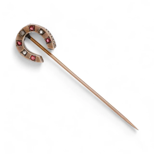 Horseshoe-shaped diamonds tie pin, circa 1940.