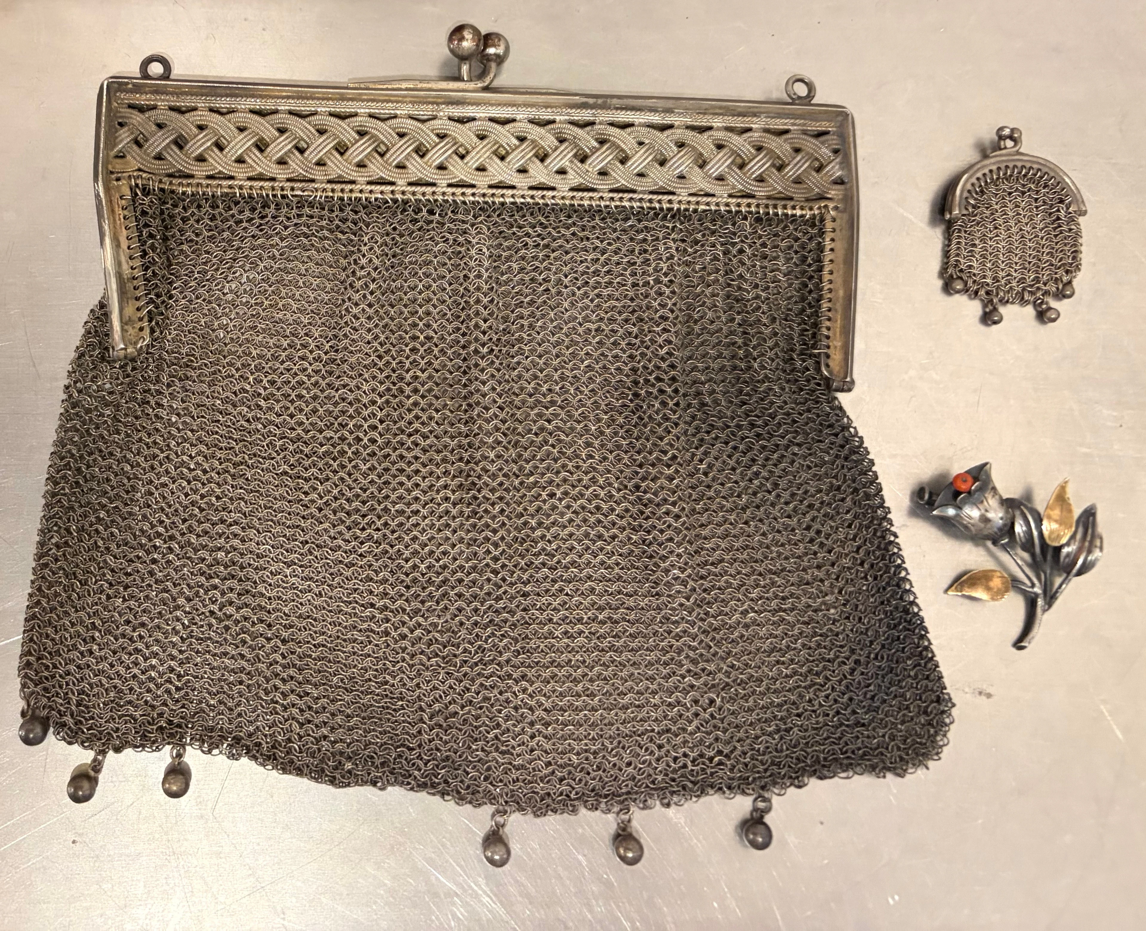Silver bag, miniature silver bag, and silver brooch, circa 1930.