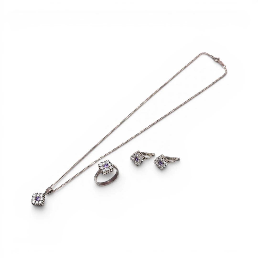 Set of ring, earrings and pendant with zircons.