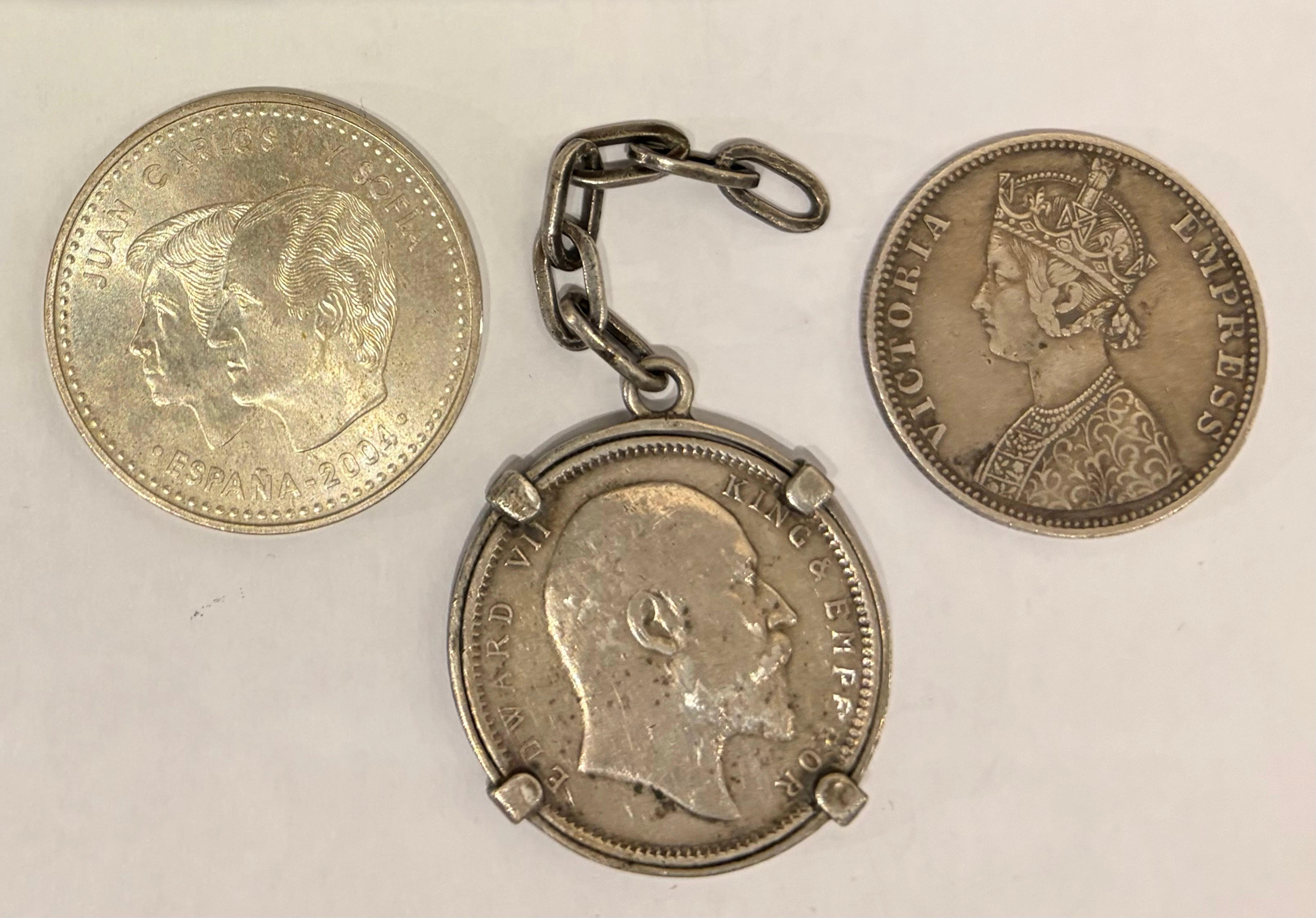 Three silver coins, two British India 1 rupee coins of Queen Victoria