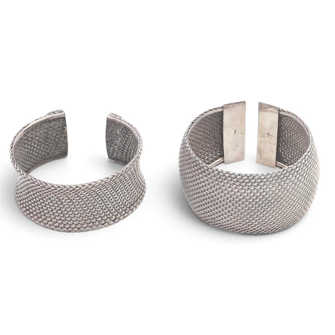 Two wide mesh bangles in silver.