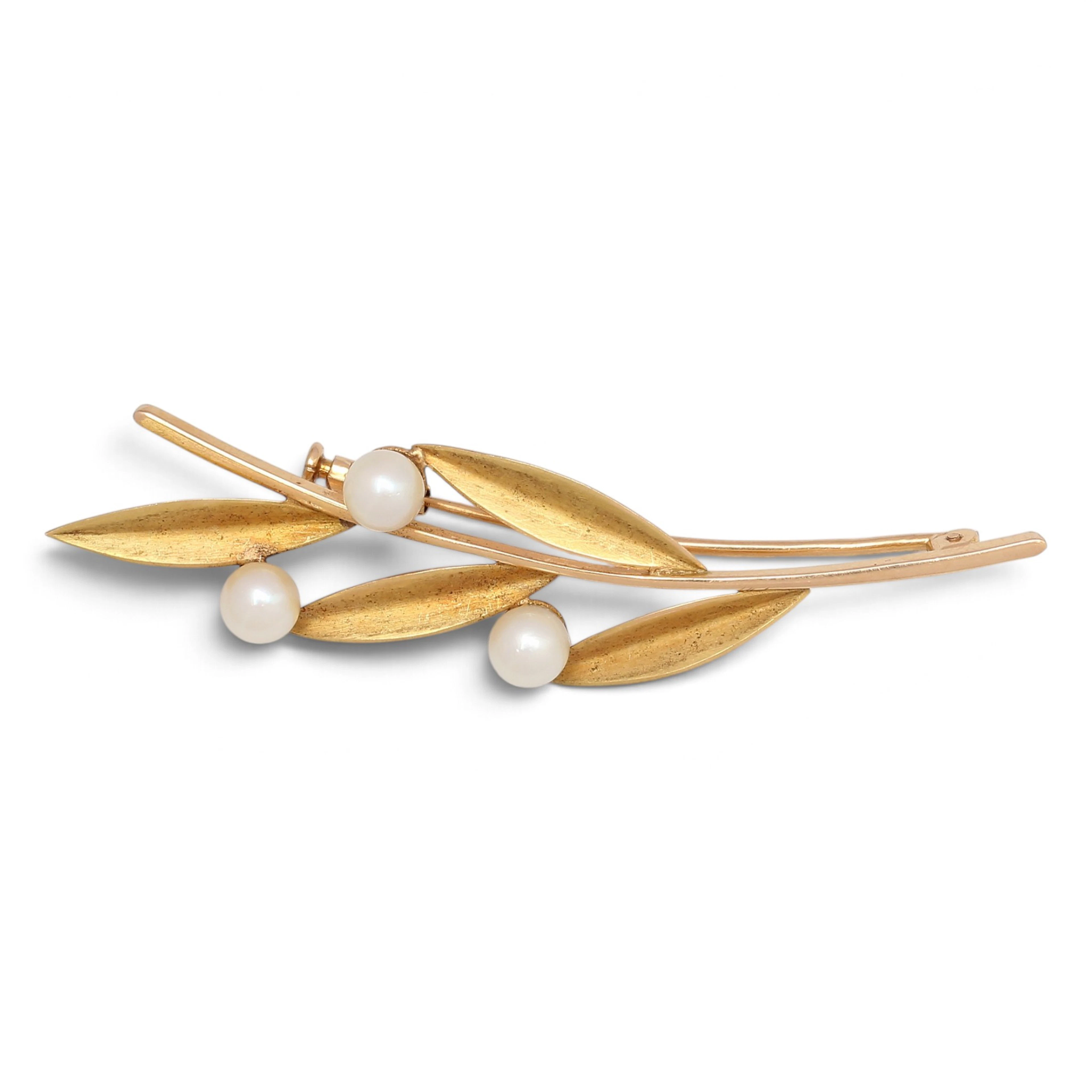 Gold brooch in the shape of an olive branch.
