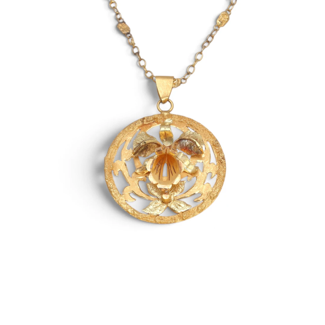CIRCULAR orchid pendant in gold, mid-20th century.