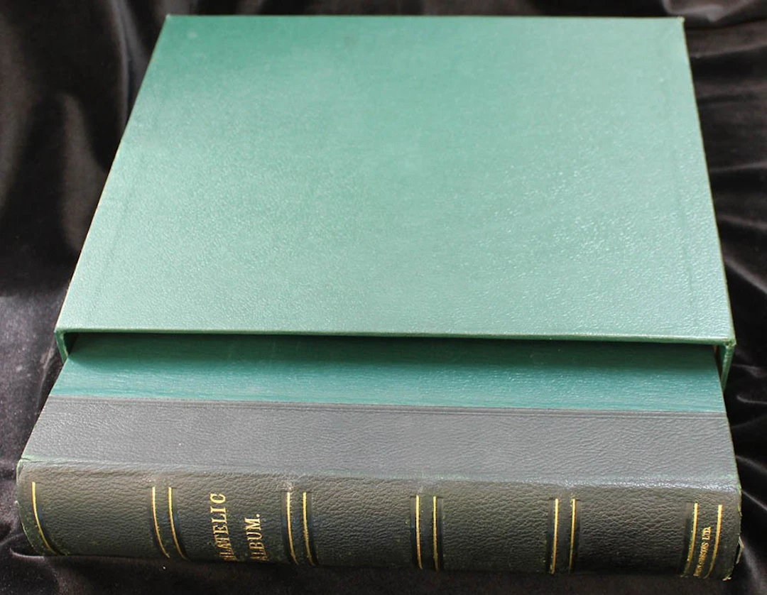 PHILATELIC ALBUM (large green album with slip case) with 27 linen hinged leaves