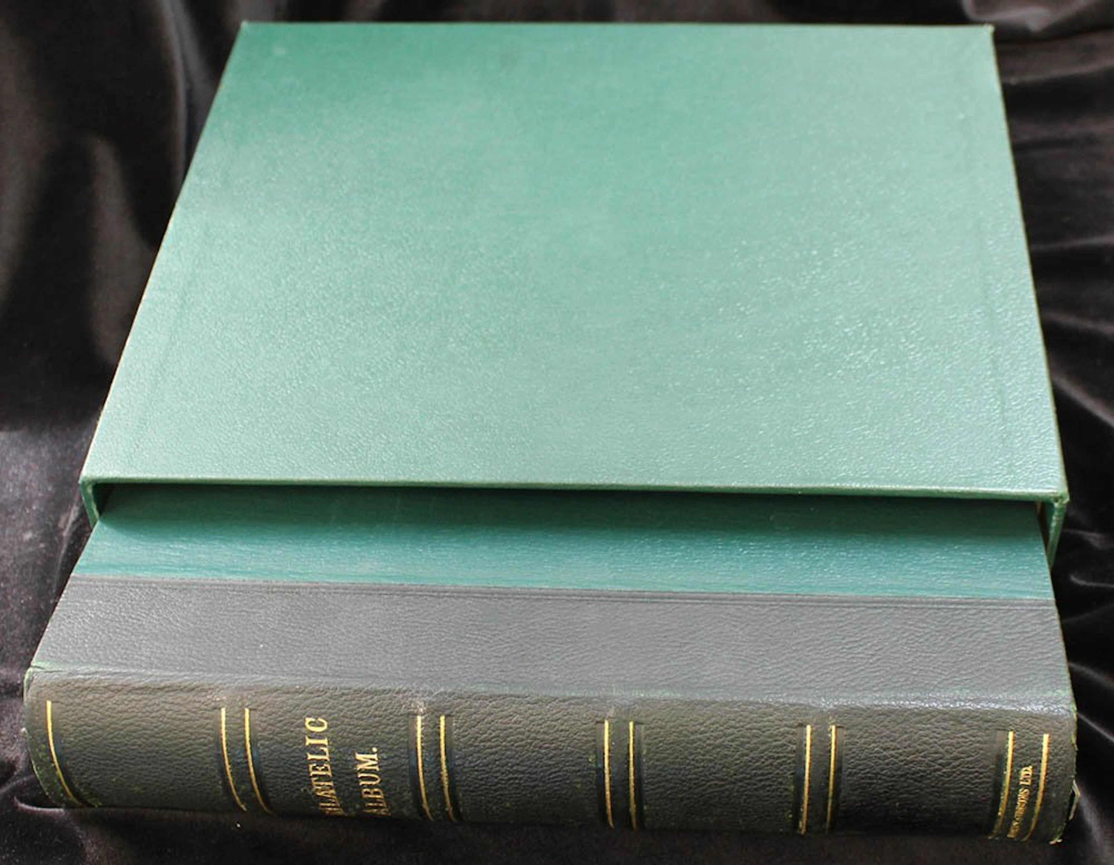 PHILATELIC ALBUM (large green album with slip case) with 27 linen hinged leaves