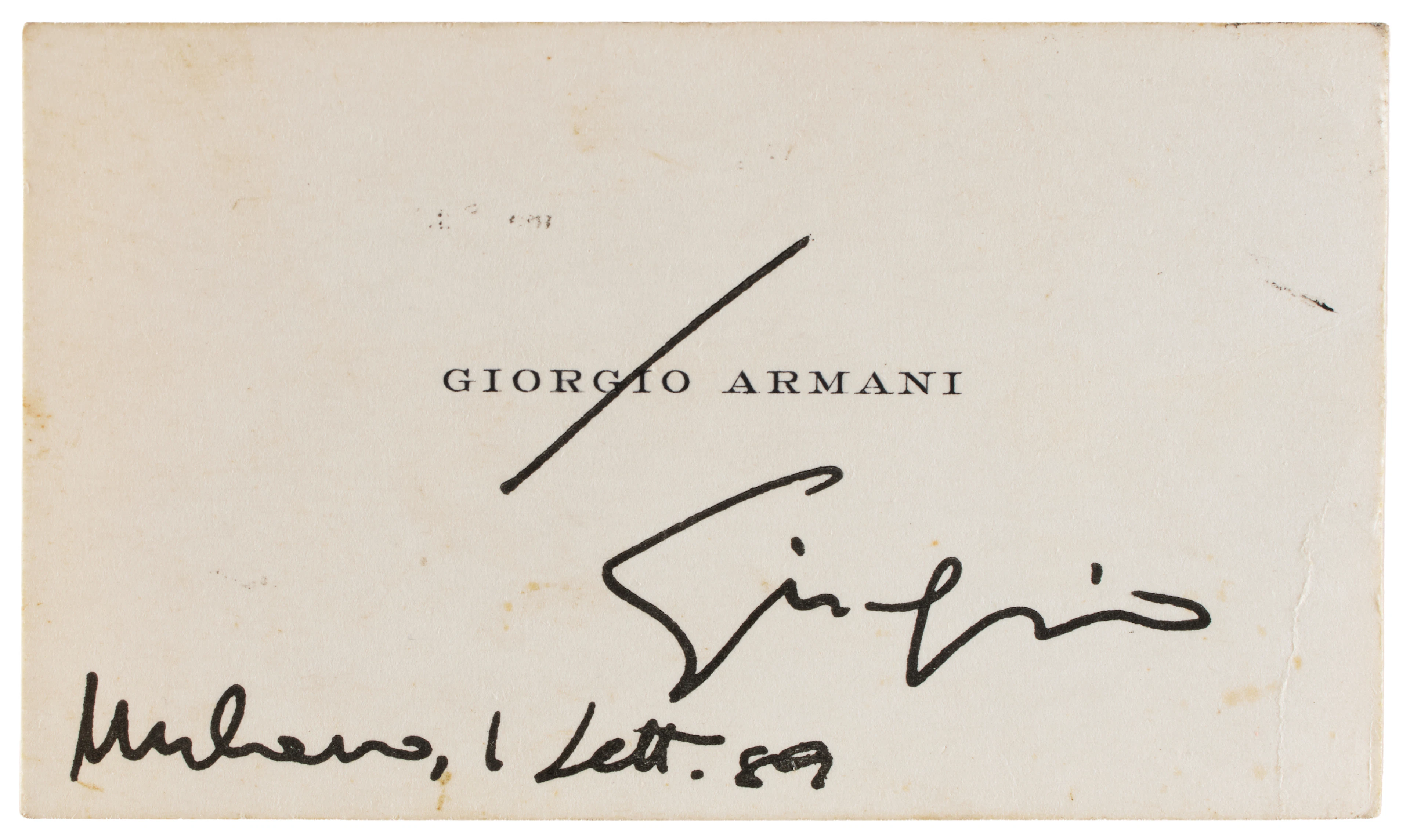 ARMANI, Giorgio (1934-). Biglietto da visita con firma autografa datata.