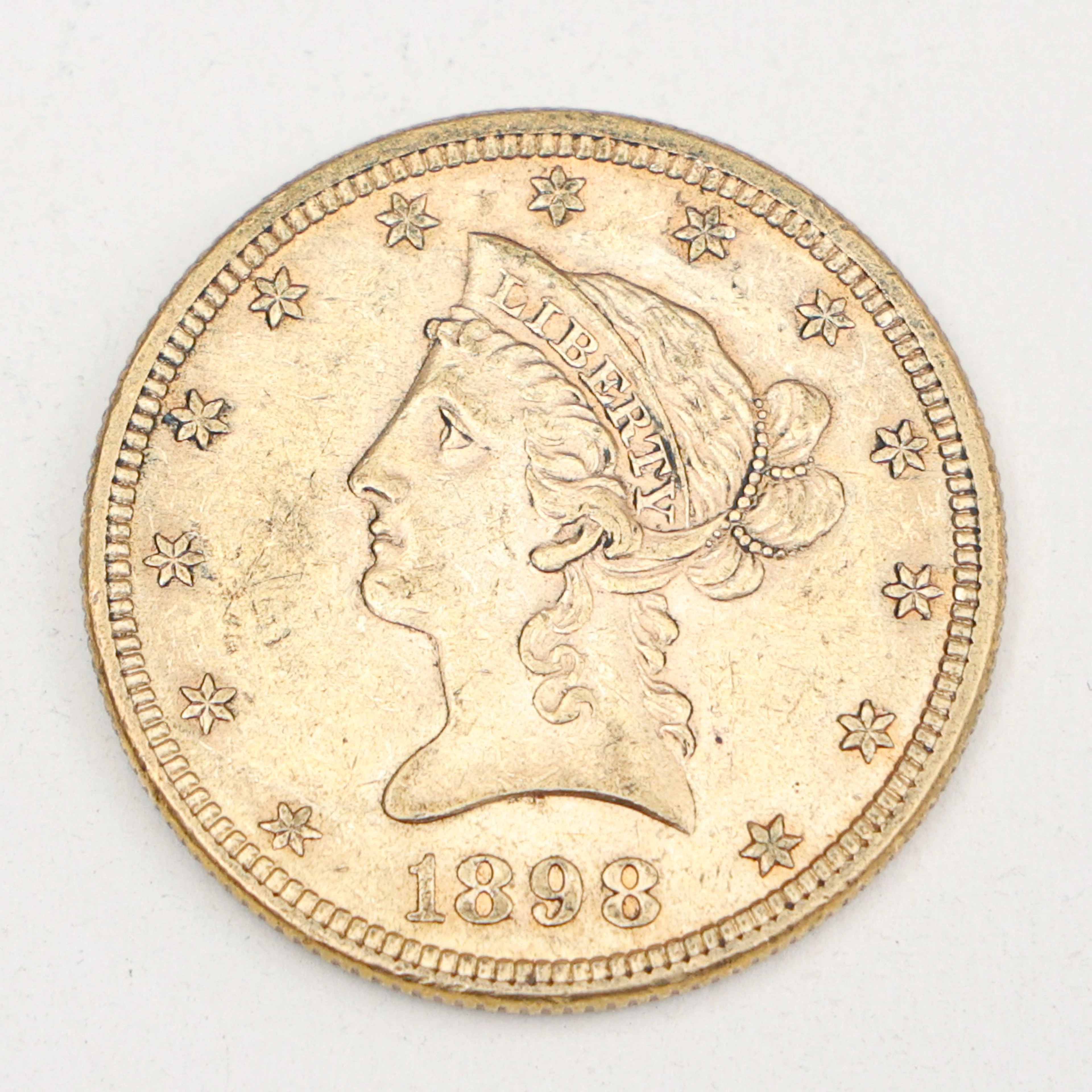 MYNT,21,6 karat guld, 10 dollar,"Liberty Head Eagle", 1898,vikt 16,8 gram.