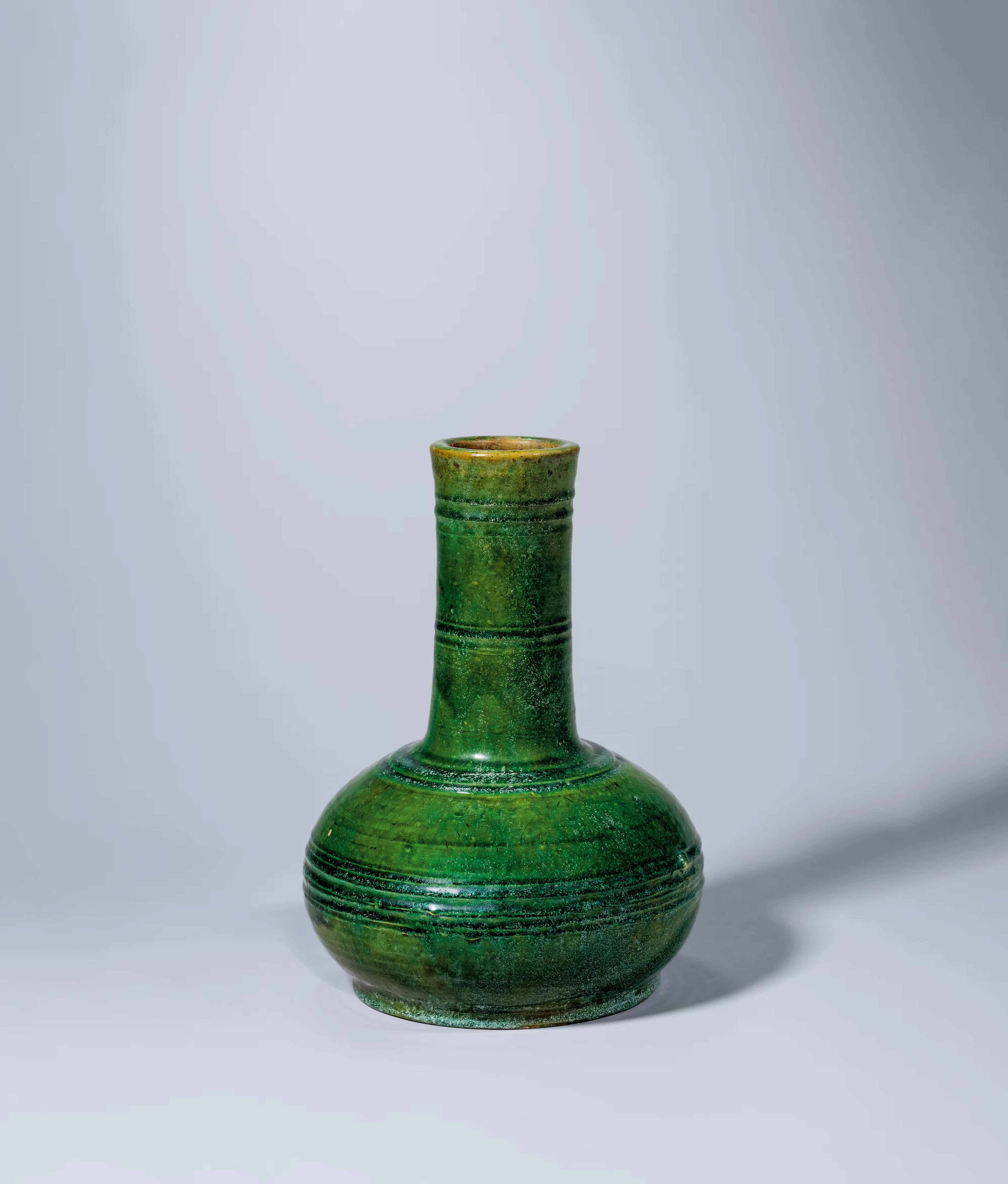 A GREEN-GLAZED BOTTLE VASE, HAN DYNASTY, 246 B.C.- 220
