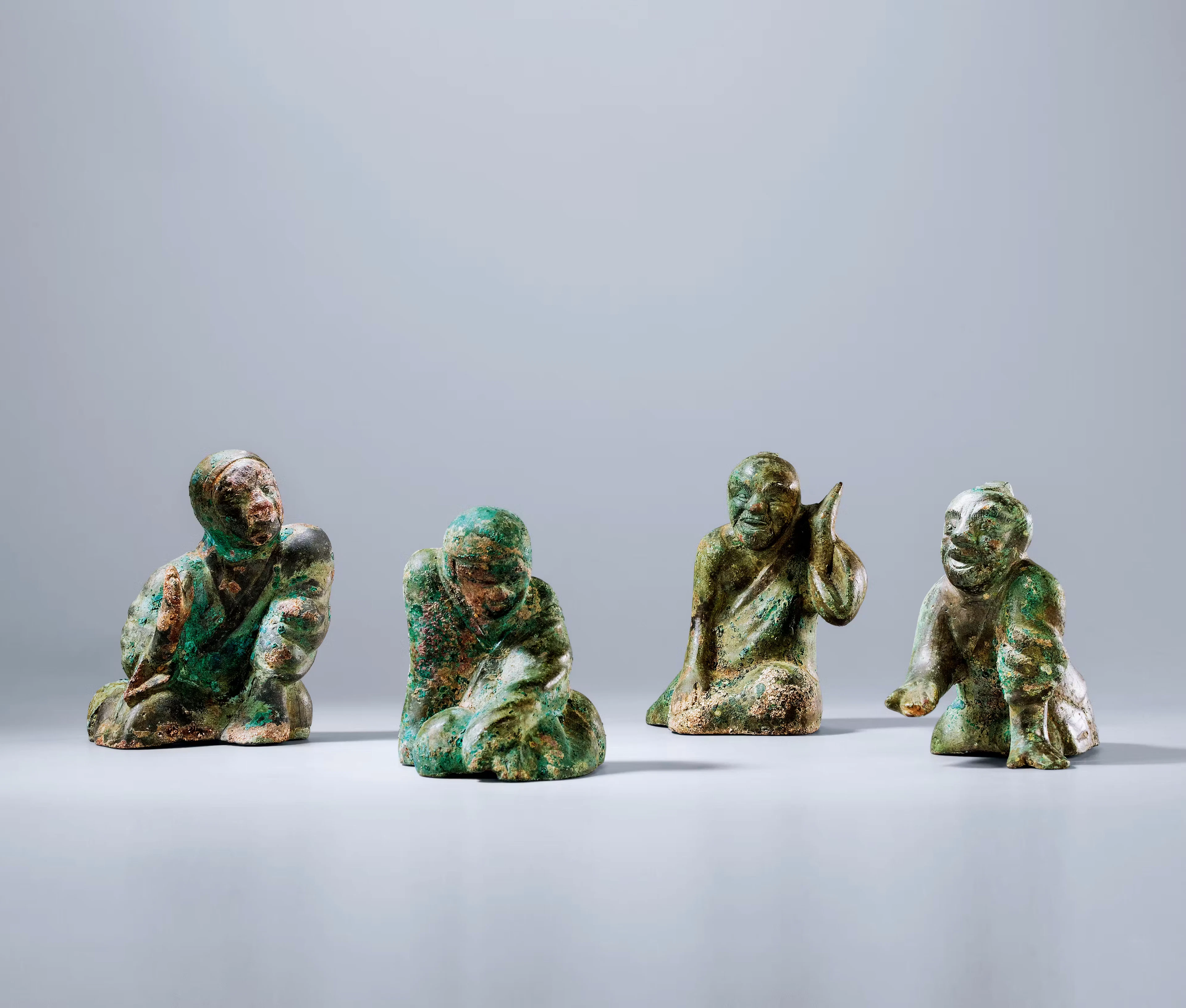 A GROUP OF FOUR ARCHAIC BRONZE 'FIGURAL' WEIGHTS, WESTERN HAN DYNASTY