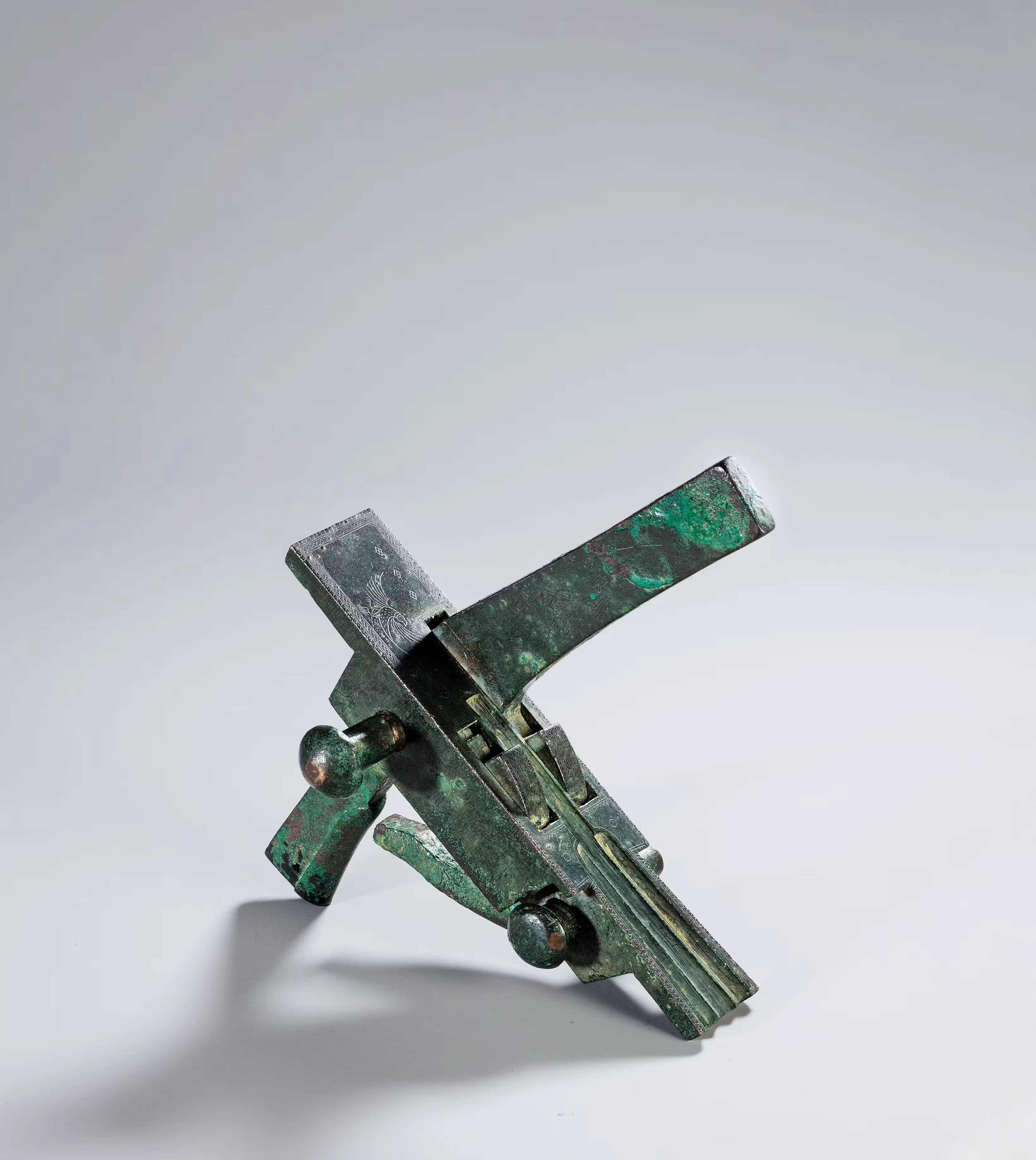 AN ARCHAIC BRONZE 'PHOENIX' CROSS-BOW, HAN DYNASTY, 246 B.C.- 220