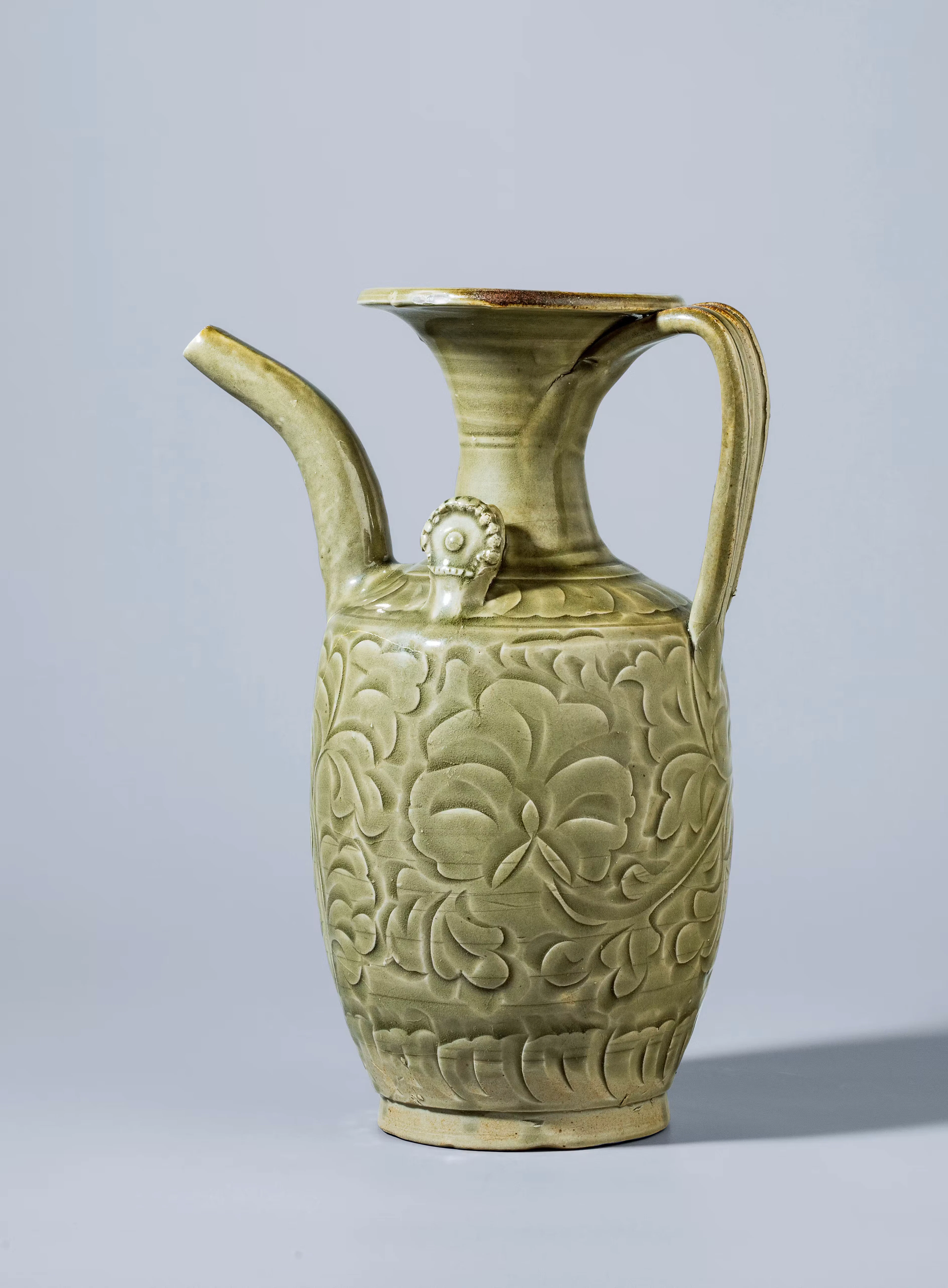 A CARVED YAOZHOU CELADON 'PEONY' EWER, SONG DYNASTY, 960-1279