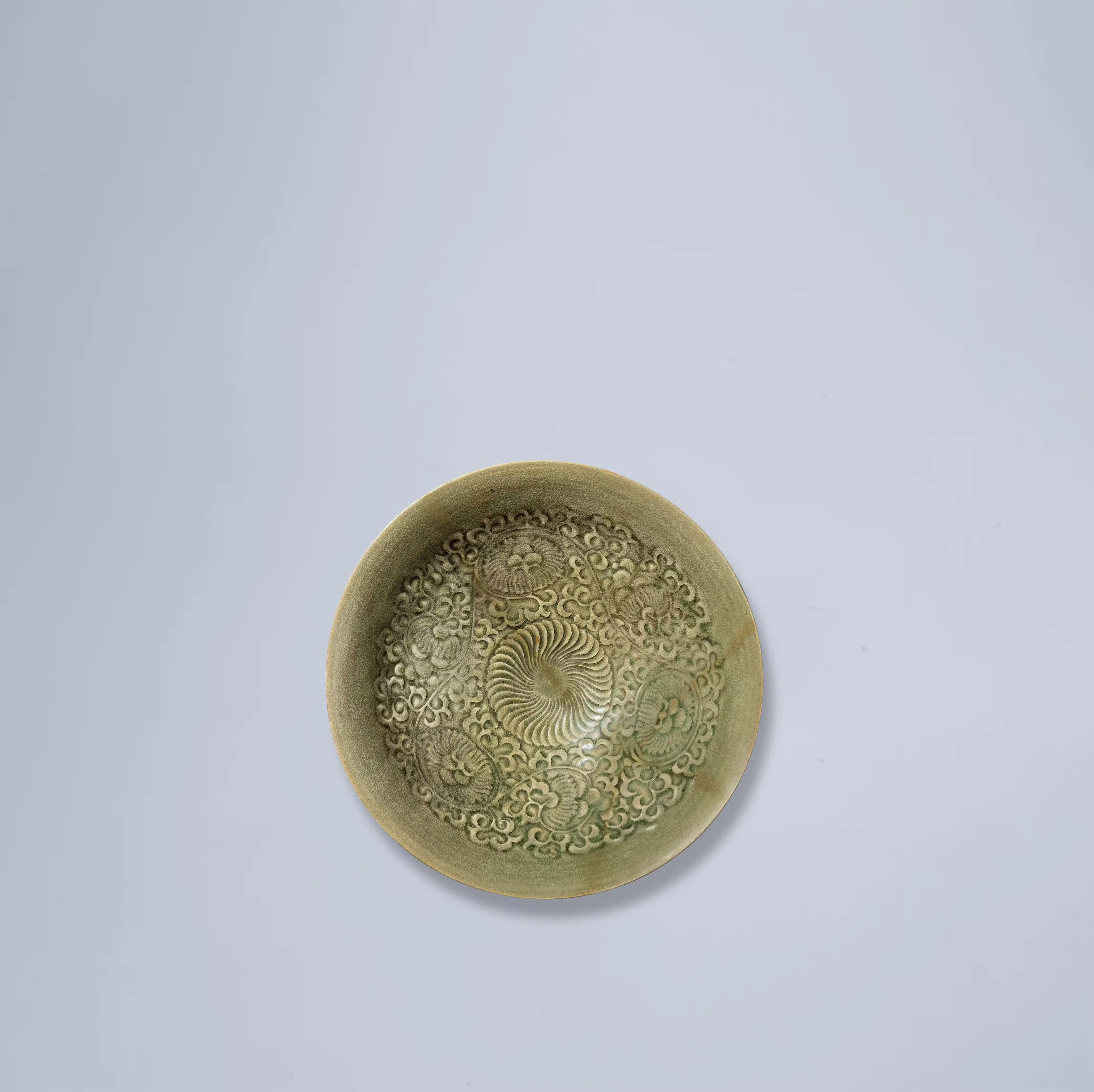 A LARGE YAOZHOU CELADON 'FLORAL' BOWL, SONG DYNASTY TO JIN DYNASTY