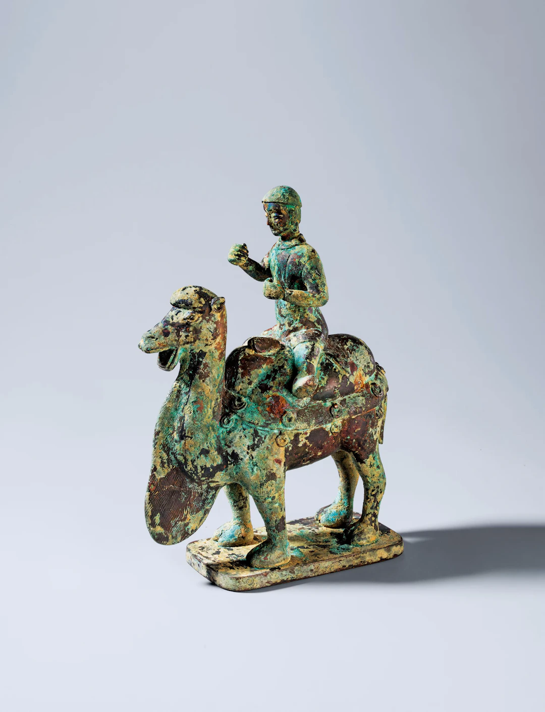 AN ARCHAIC BRONZE FIGURE OF A CAMEL AND RIDER, SUI DYNASTY, 581-618