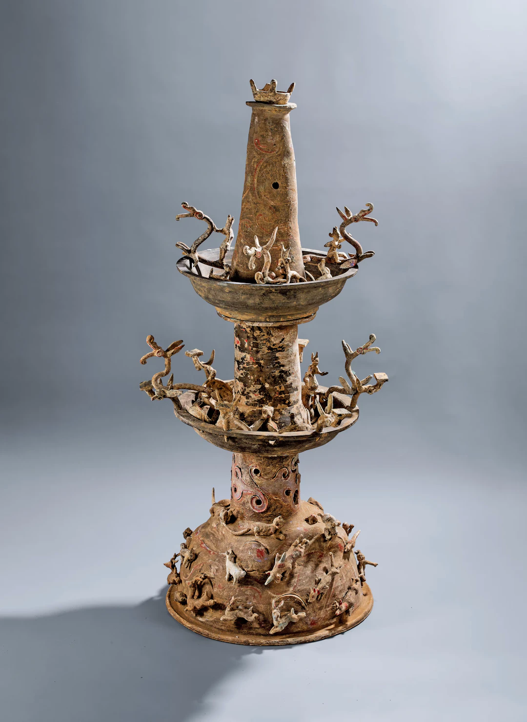 A PAINTED POTTERY THREE-TIERED LAMP, EASTERN HAN DYNASTY, A.D. 25-220