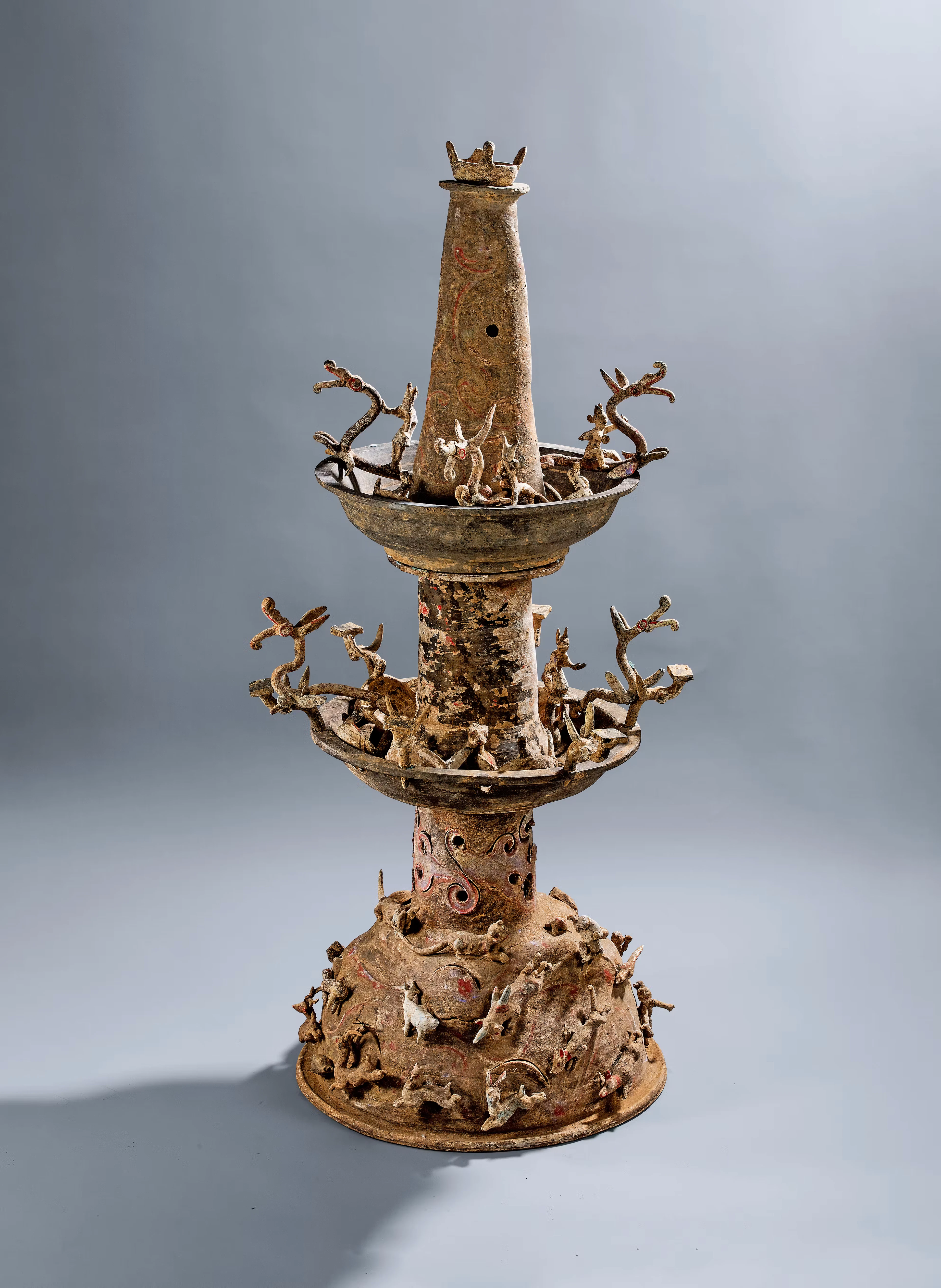 A PAINTED POTTERY THREE-TIERED LAMP, EASTERN HAN DYNASTY, A.D. 25-220