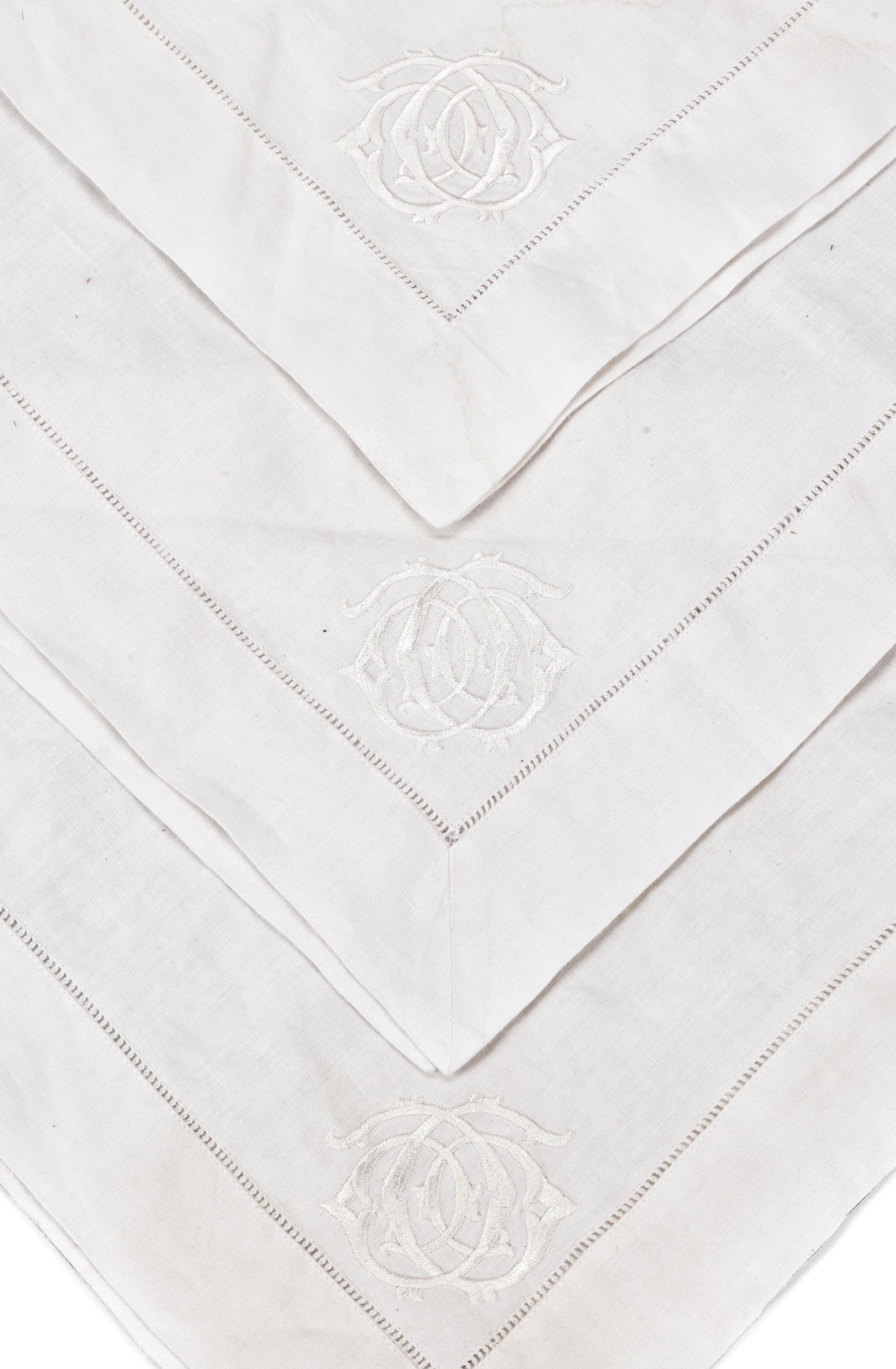 A set of twenty-six monogrammed rectangular linen napkins Acquired