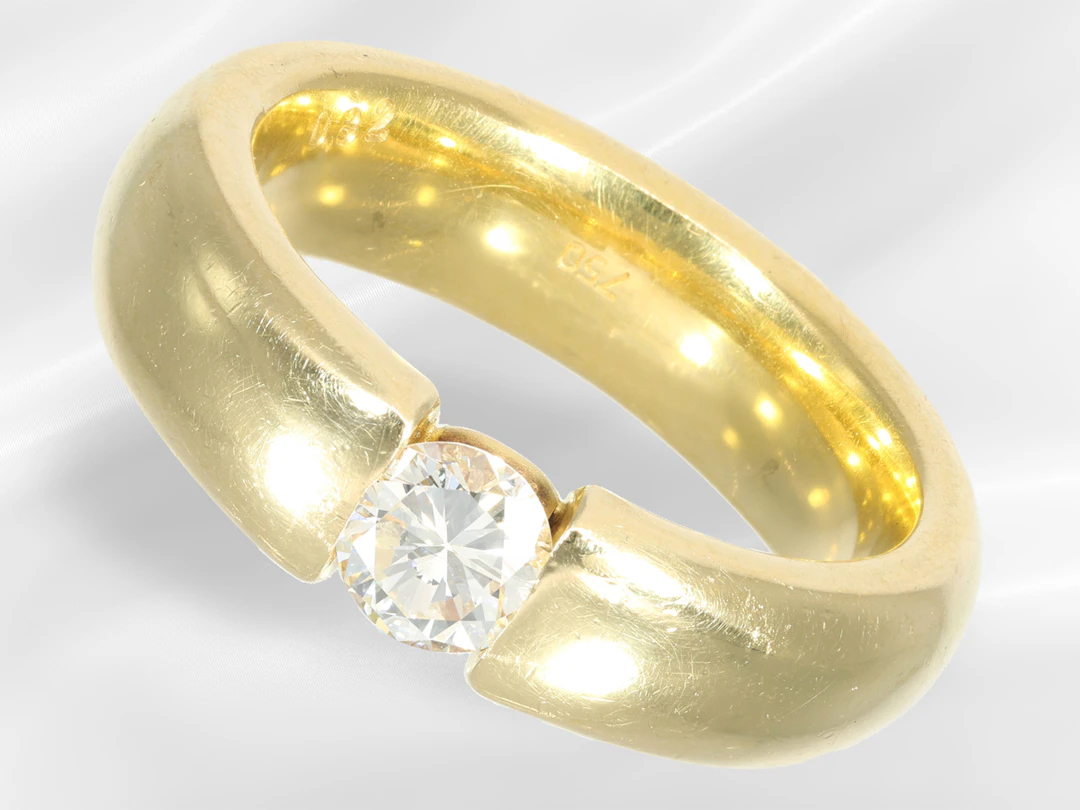 Ring: a substantial and heavy solitaire diamond tension ring, featuring