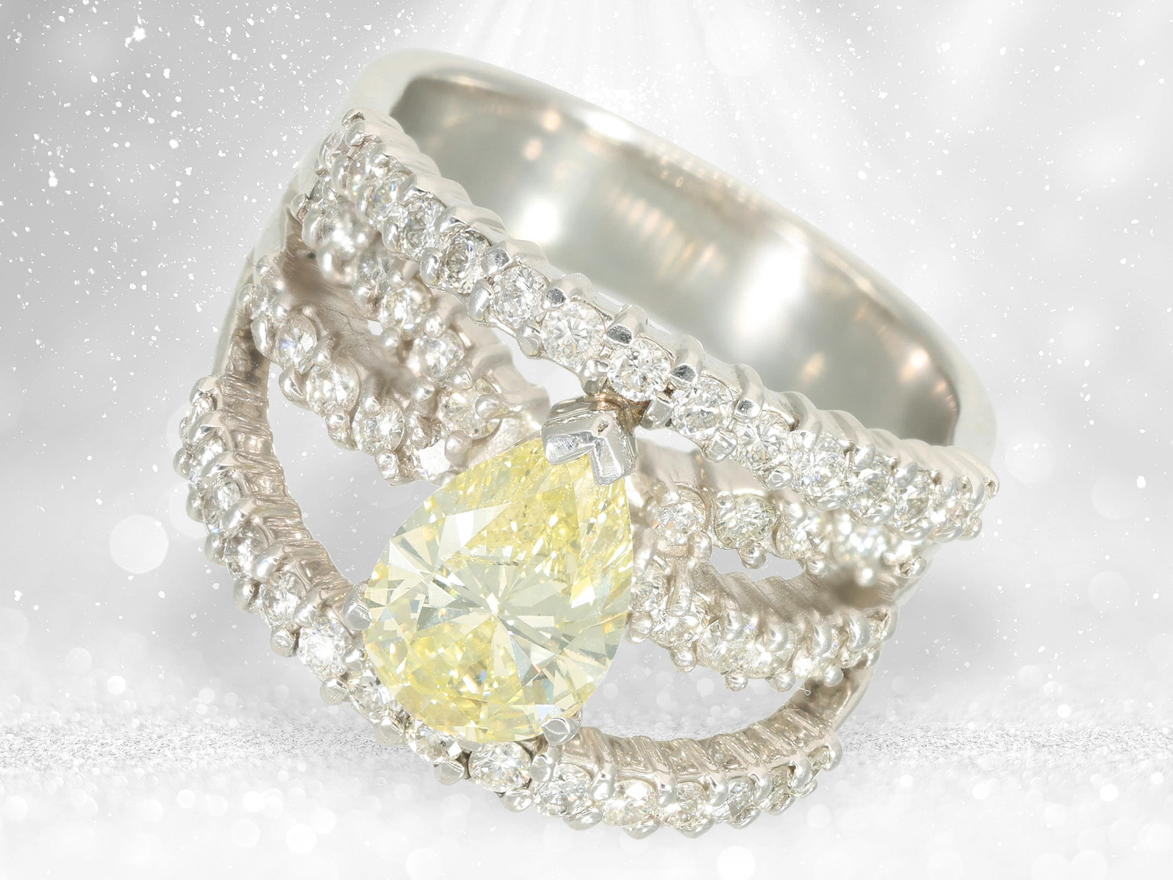 Ring: modern platinum designer ring with a large fancy yellow diamond