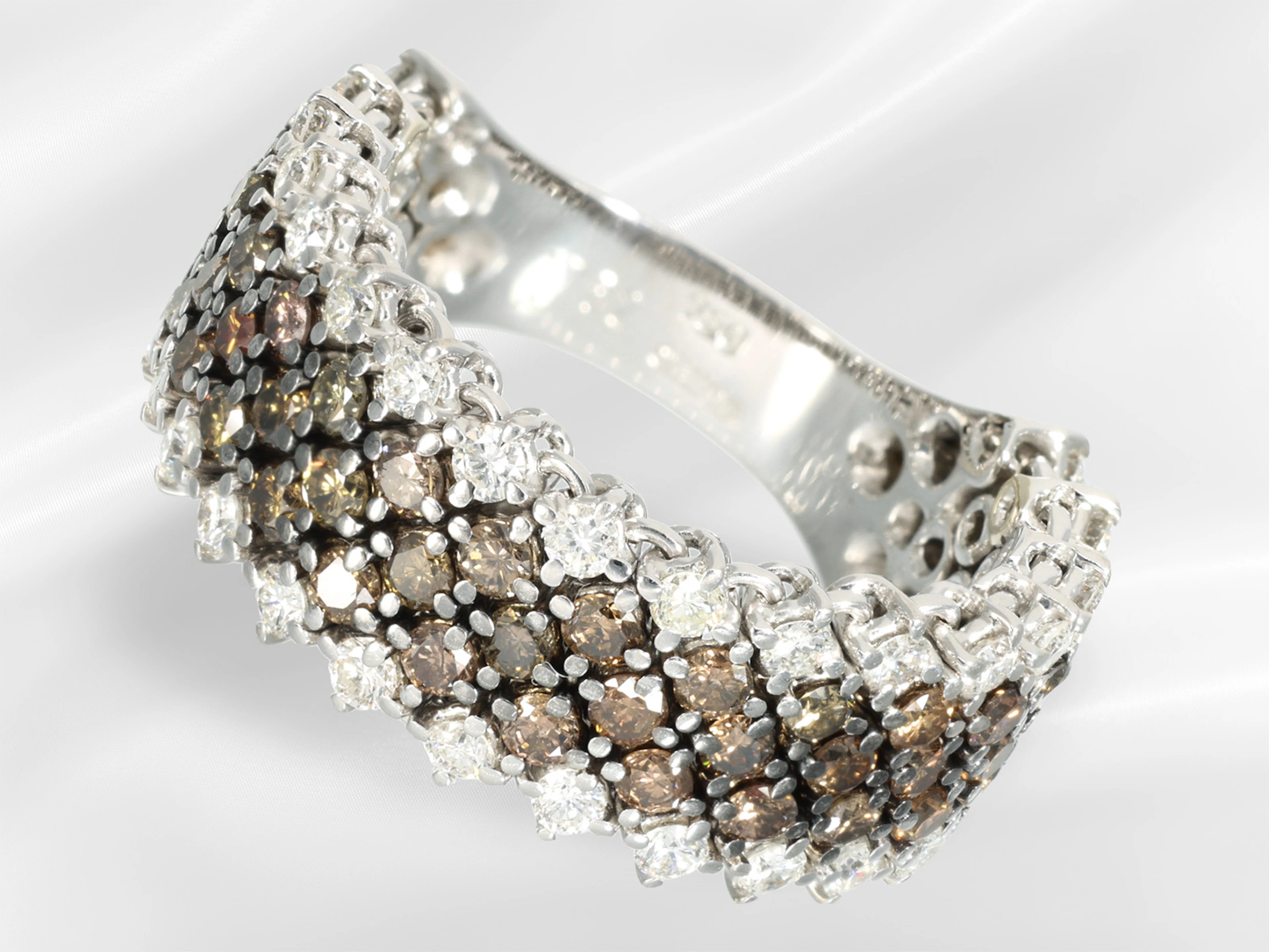 Ring: wide goldsmith's ring by Wempe, featuring fancy brown and white
