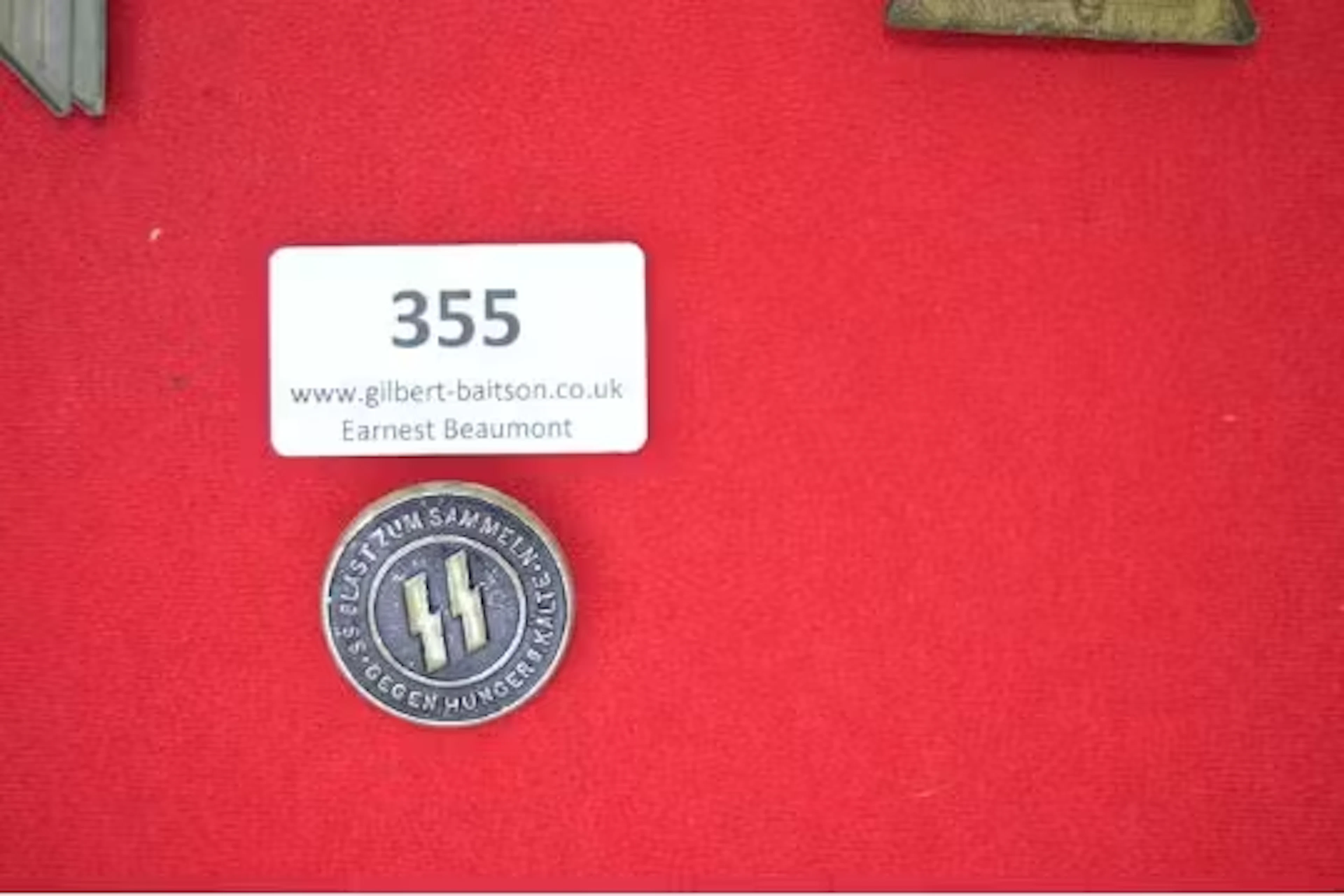SS Donation Badge – A circular pressed metal badge with black enamel