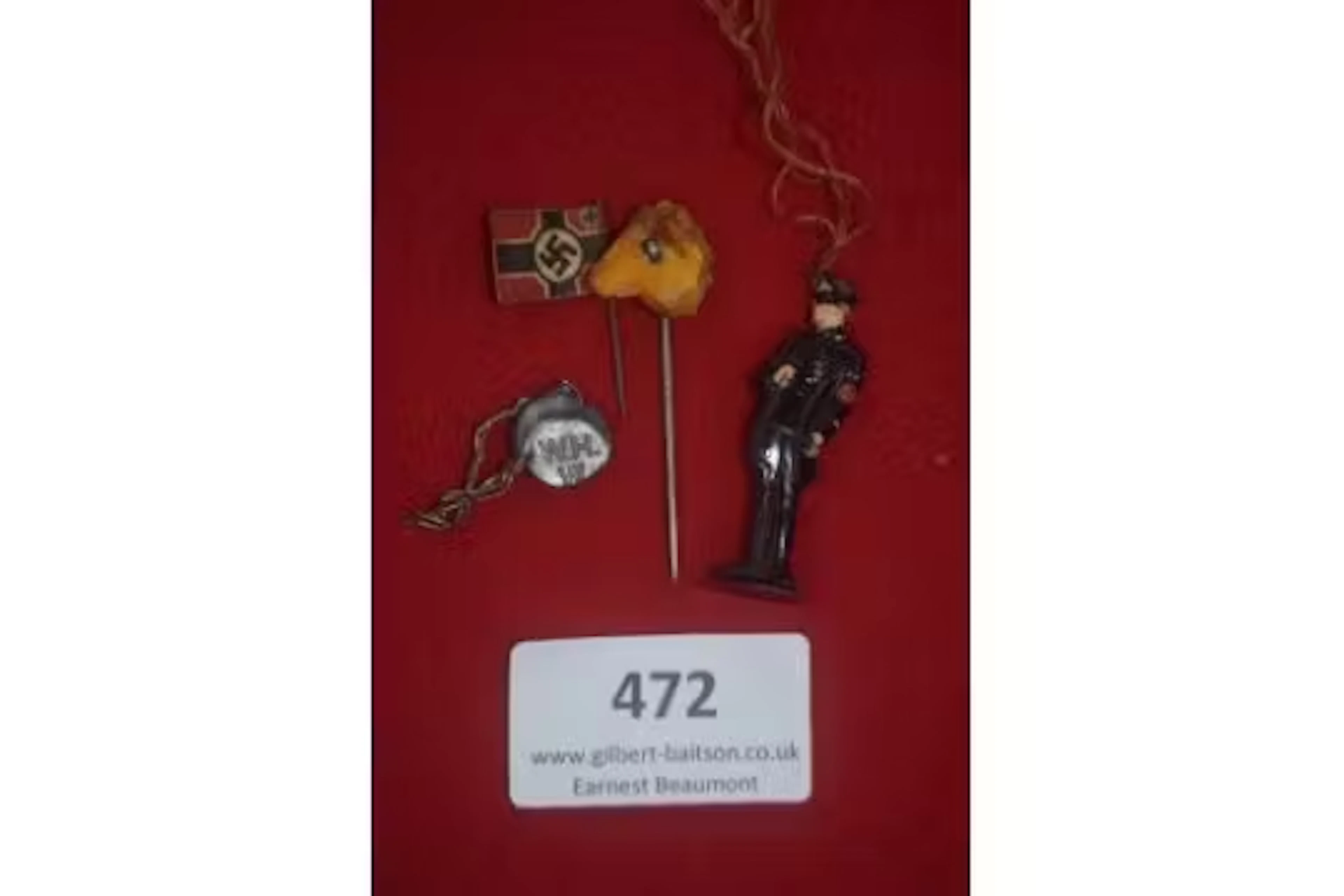 A group of four German WWII WHW day badges, comprising: a small swastika