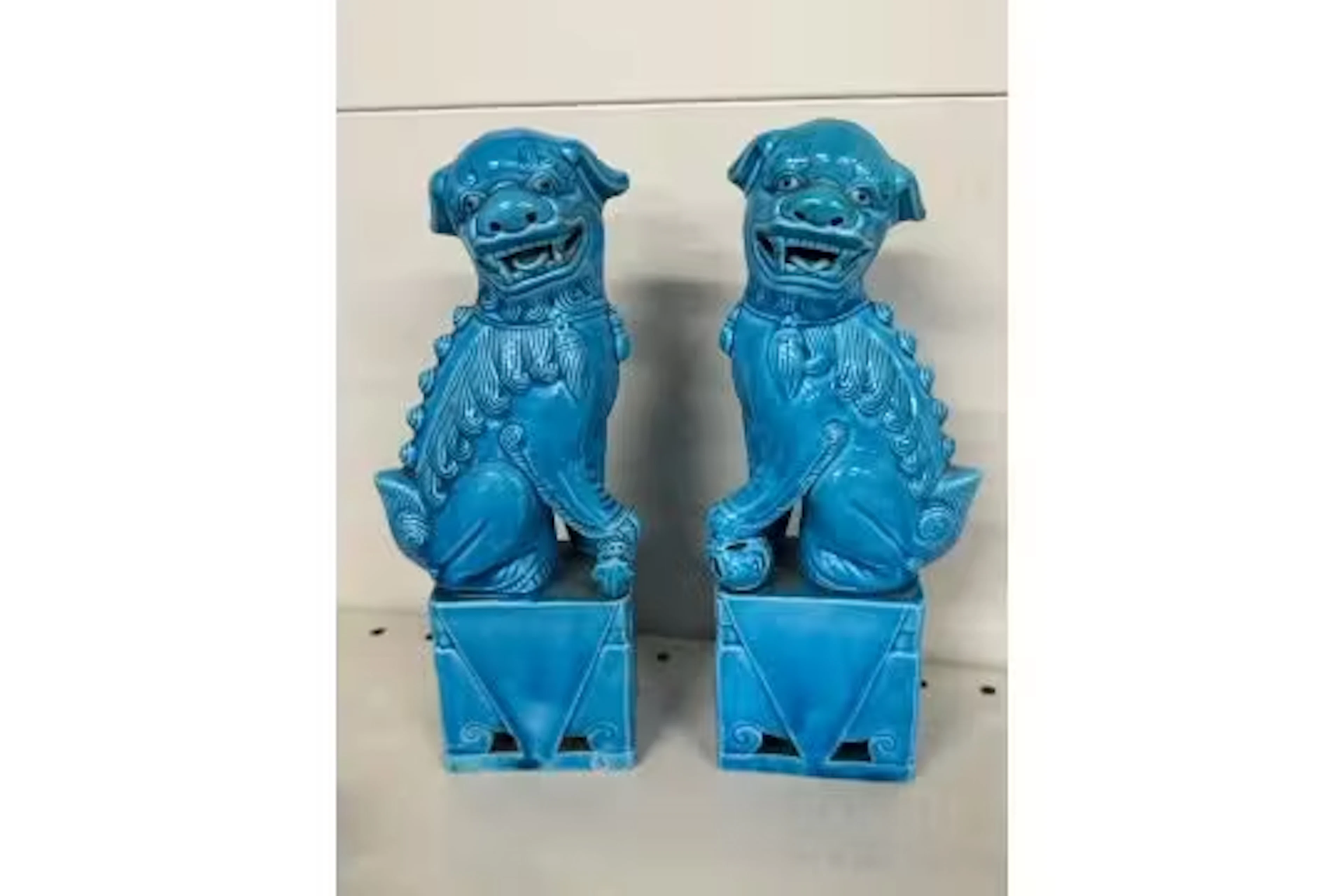 Pair of turquoise glazed porcelain foo dogs (one has been repaired)