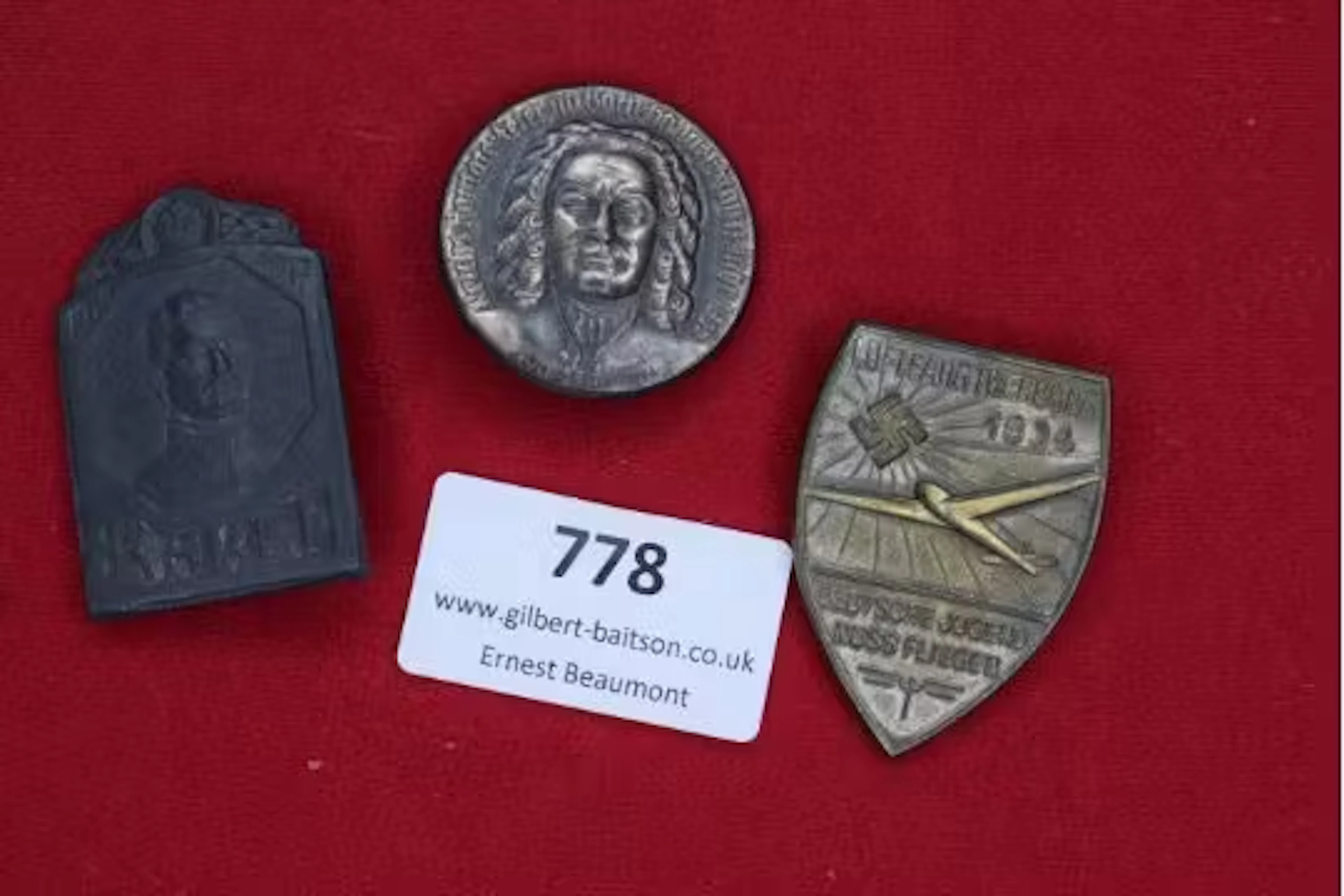 Three German badges: one blackened tin Karl I commemorative plaque