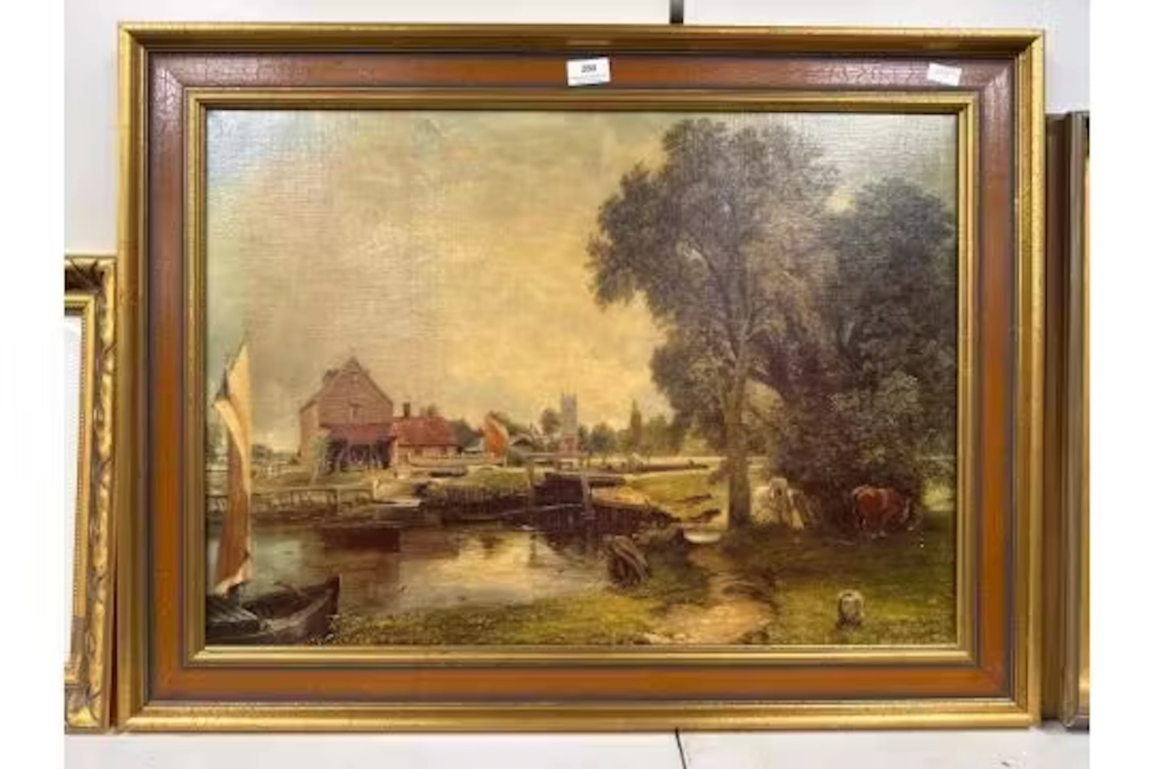 Gilt framed painted print on canvas of a countryside scene Signed
