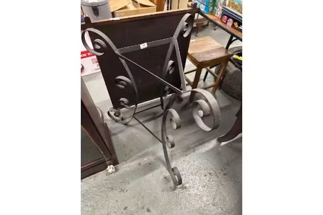 Vintage wrought iron table base with a decorative scroll design